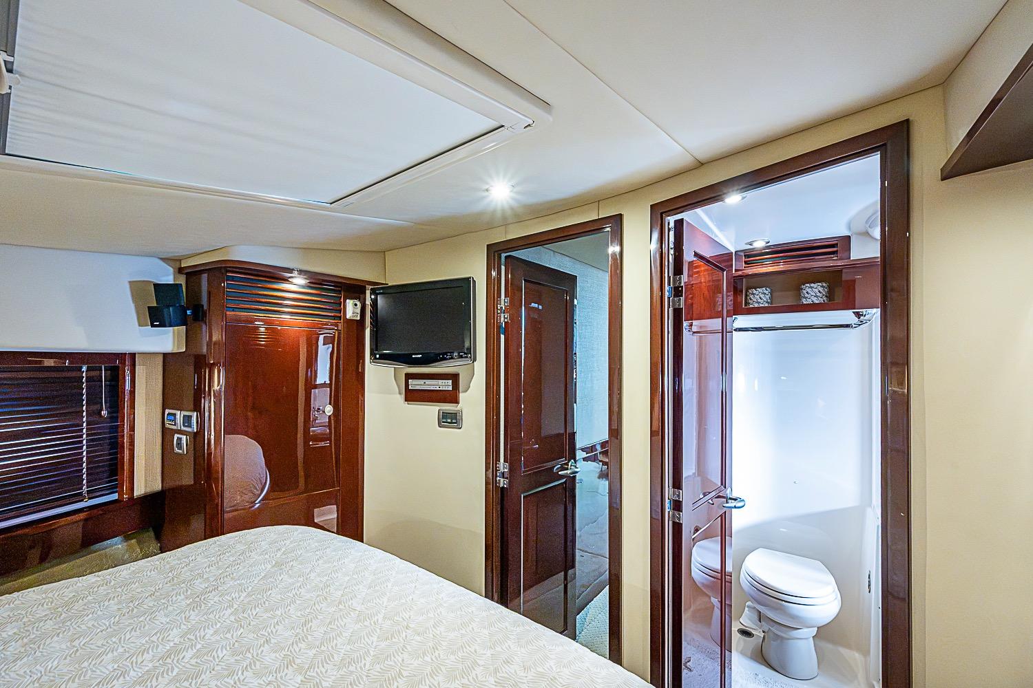 Luxurious 2008 Sea Ray 60 Sundancer yacht interior with bedroom and ensuite bathroom.