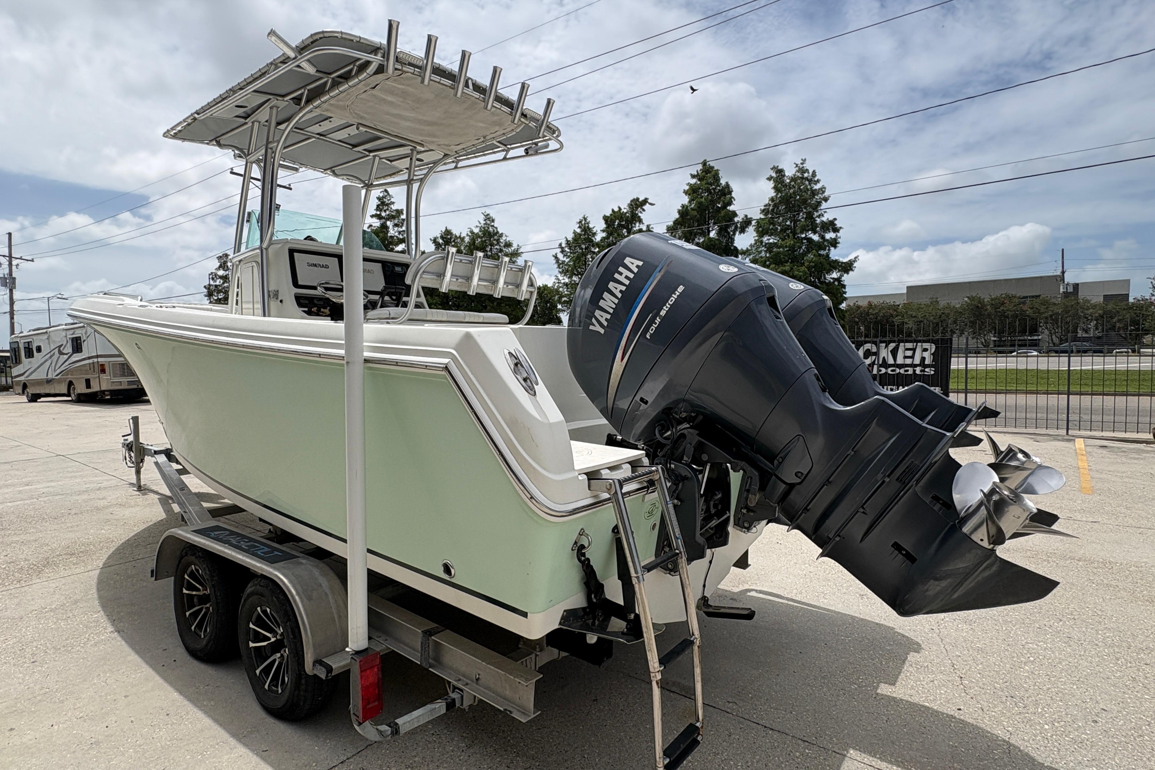 2006 Sail Faish 2360 boat with Yamaha outboard motor on trailer, parked outdoors.