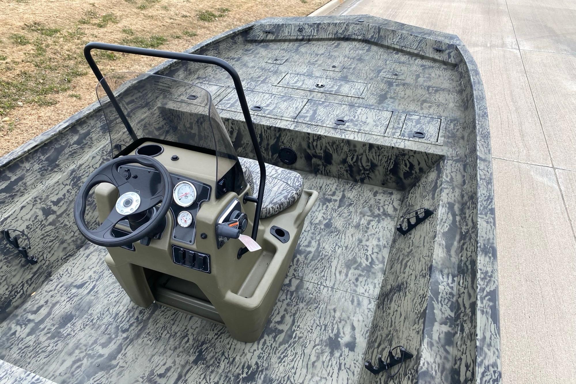 2026 Tracker Grizzly 2072 CC boat with camouflage interior and steering console.