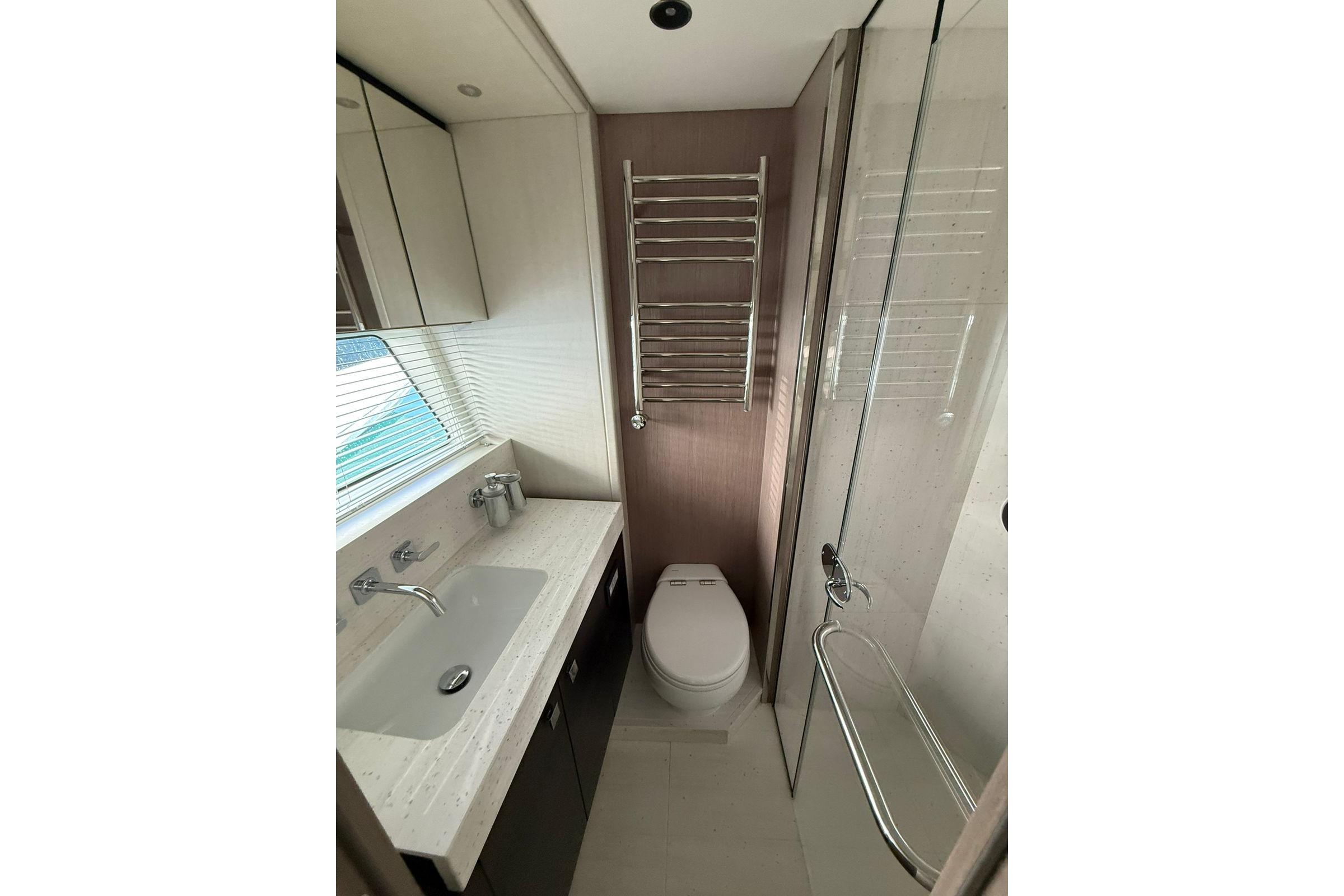 Luxurious bathroom in 2025 Sunseeker 76 Yacht with modern fixtures and elegant design.