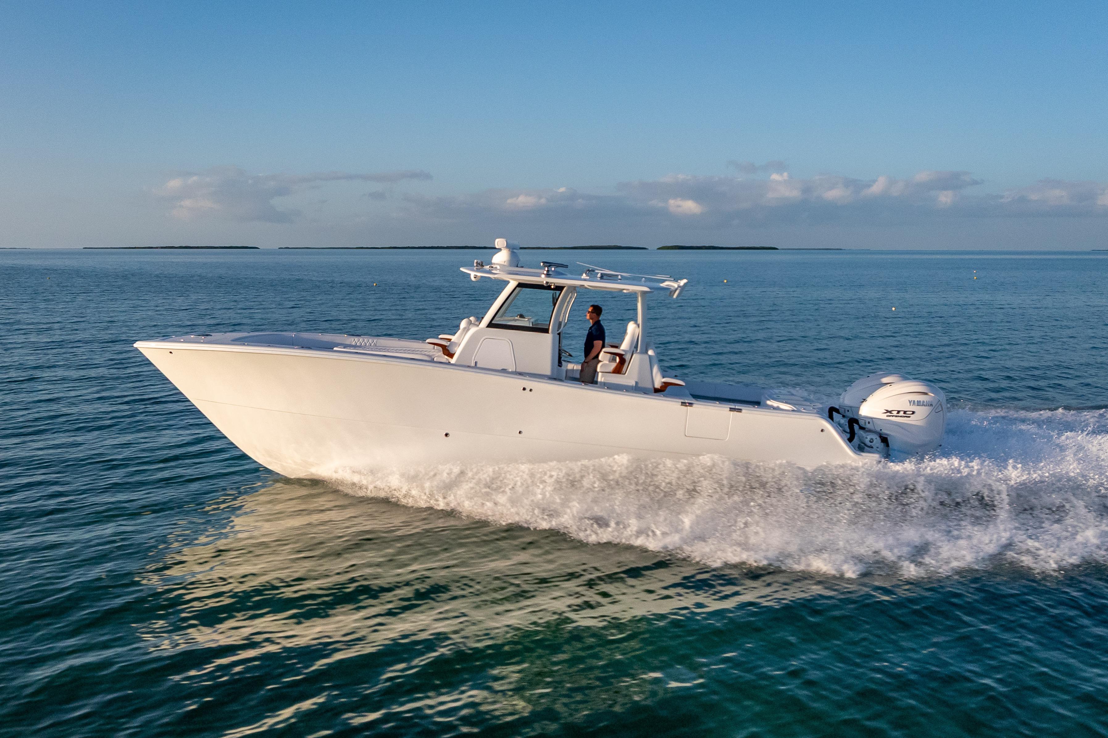 2026 Freeman 35 boat cruising on calm ocean waters under a clear blue sky.