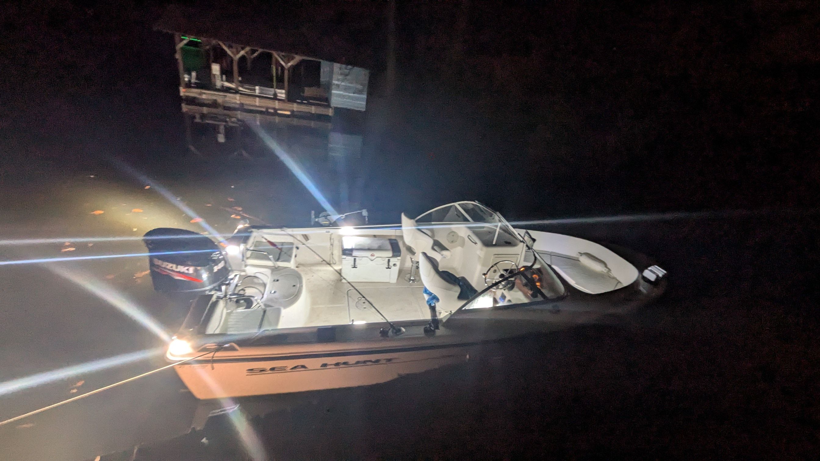 Sea Hunt Escape 200 boat at night on the water.