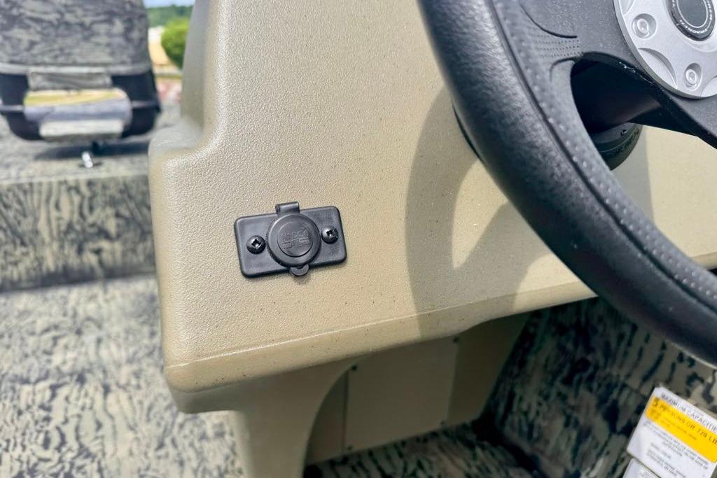 Dashboard of 2026 Tracker Grizzly 1754 SC boat with steering wheel and accessory port.