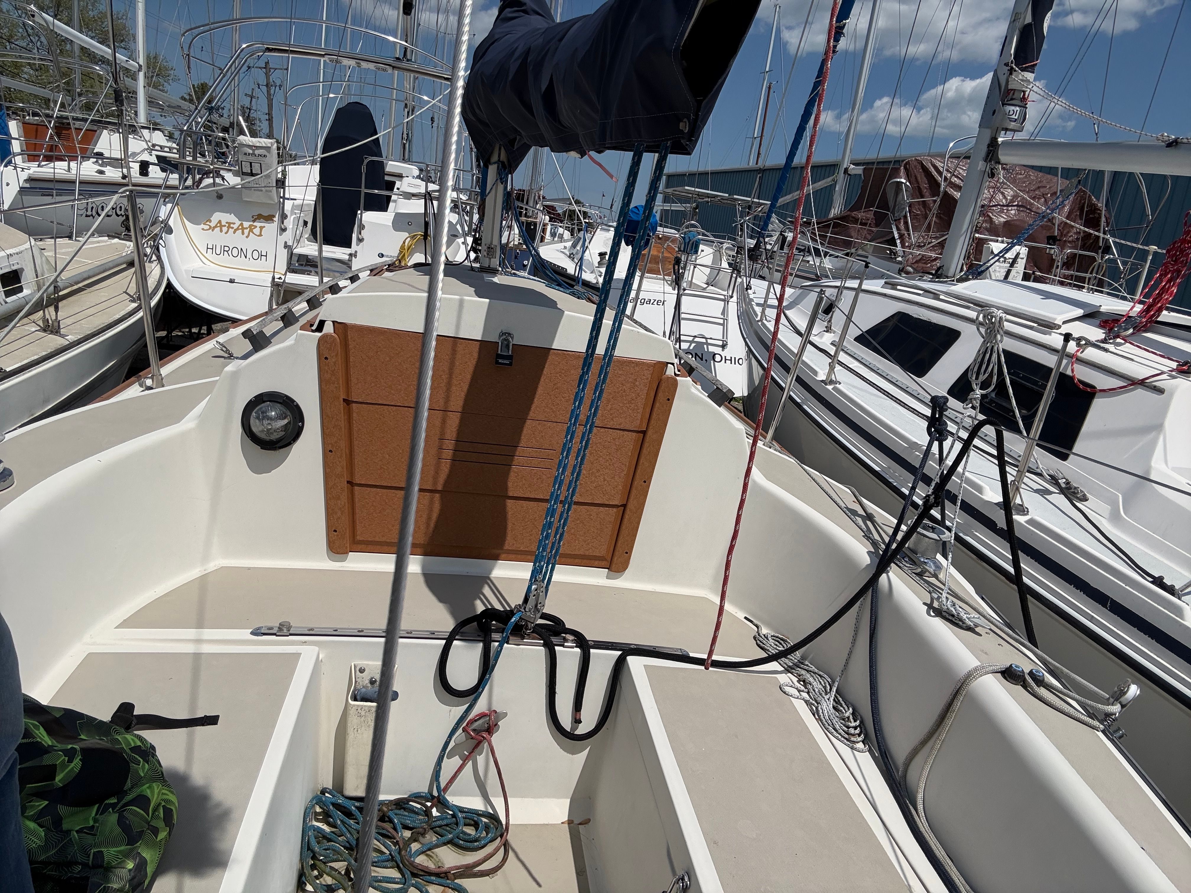 1984 O'Day 25 sailboat in harbor, featuring rigging and ropes.