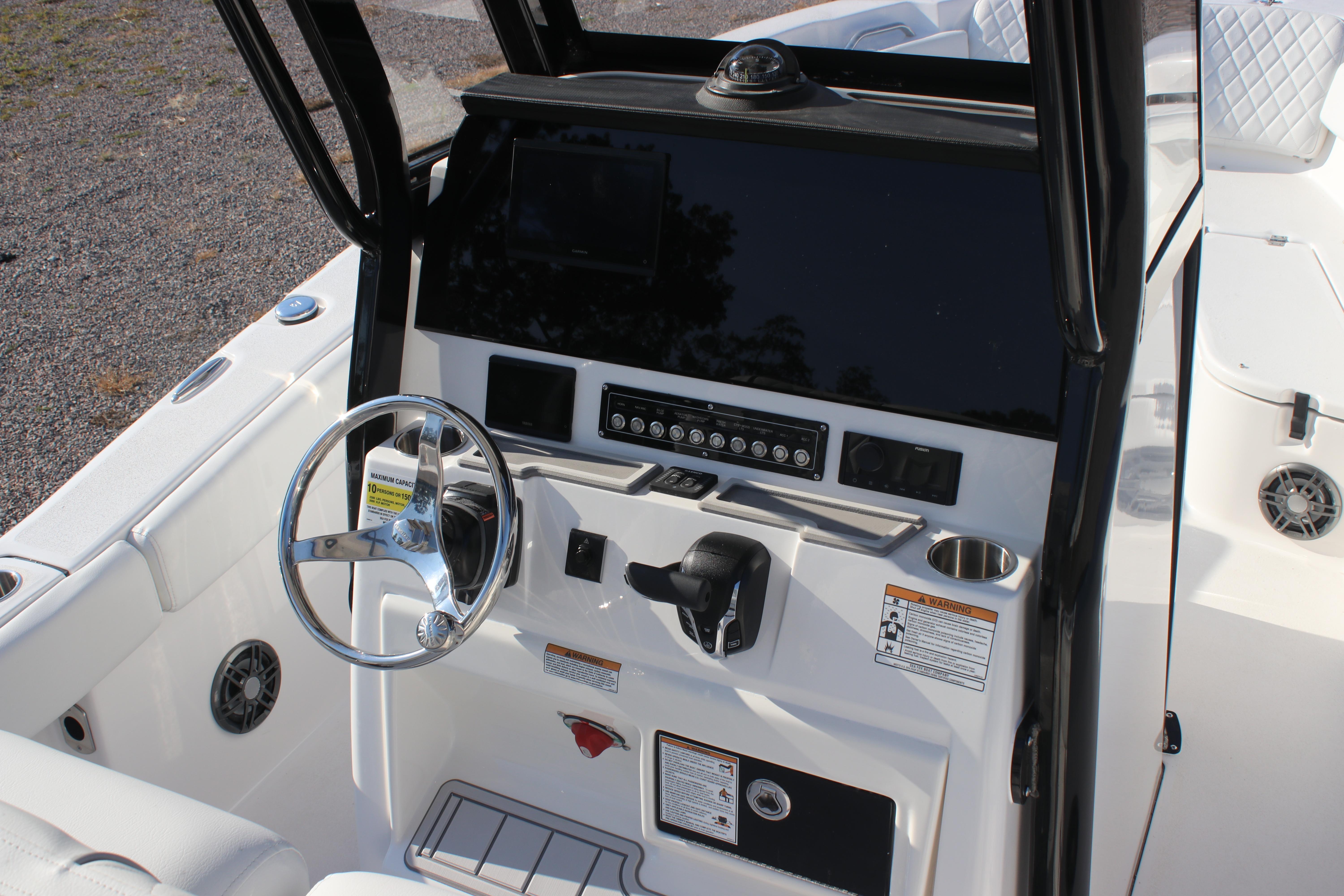 2026 Sea Fox 248 Commander boat dashboard with steering wheel and control panel.