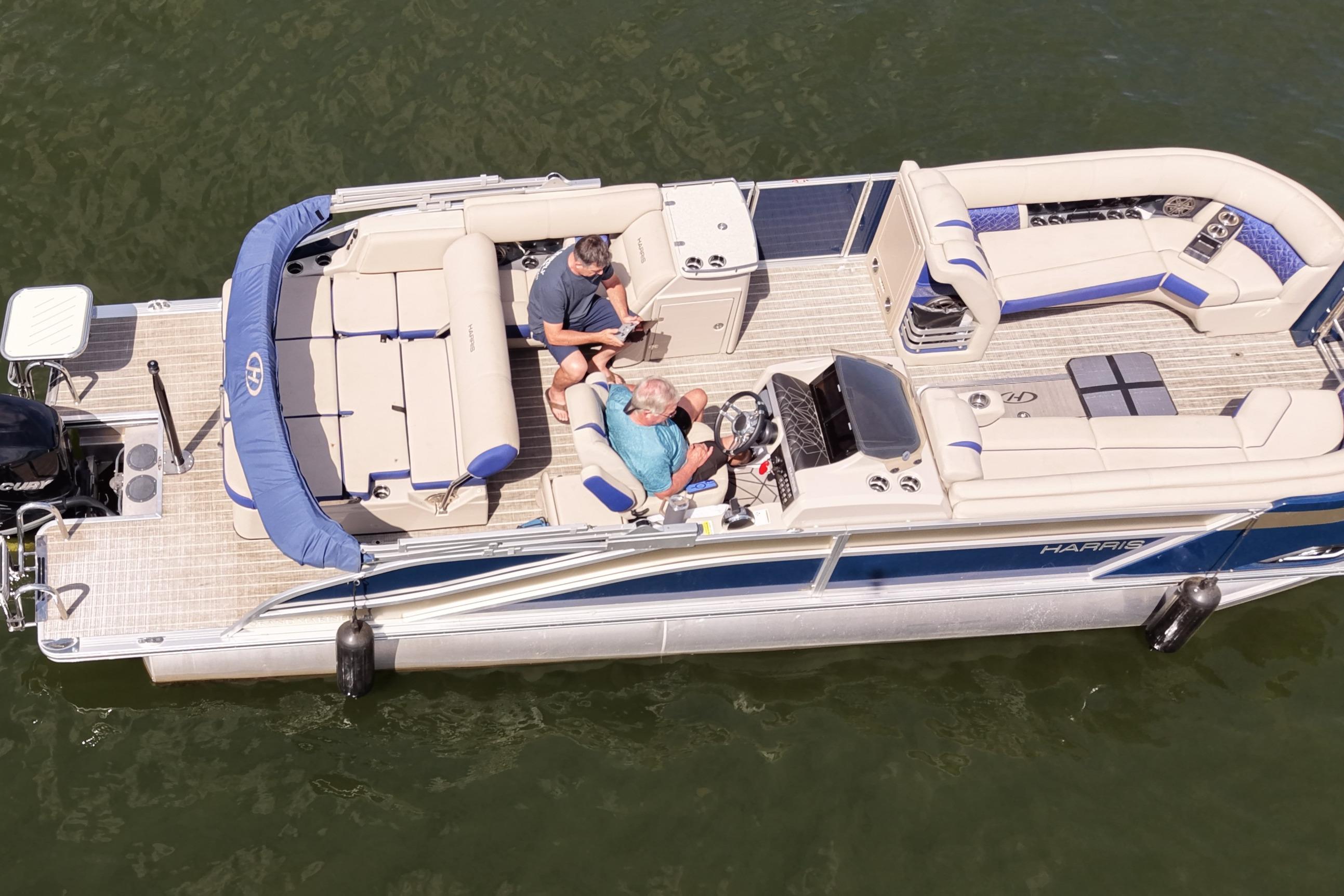 2022 Harris Grand Mariner 250 pontoon boat on water, featuring spacious seating and modern design.