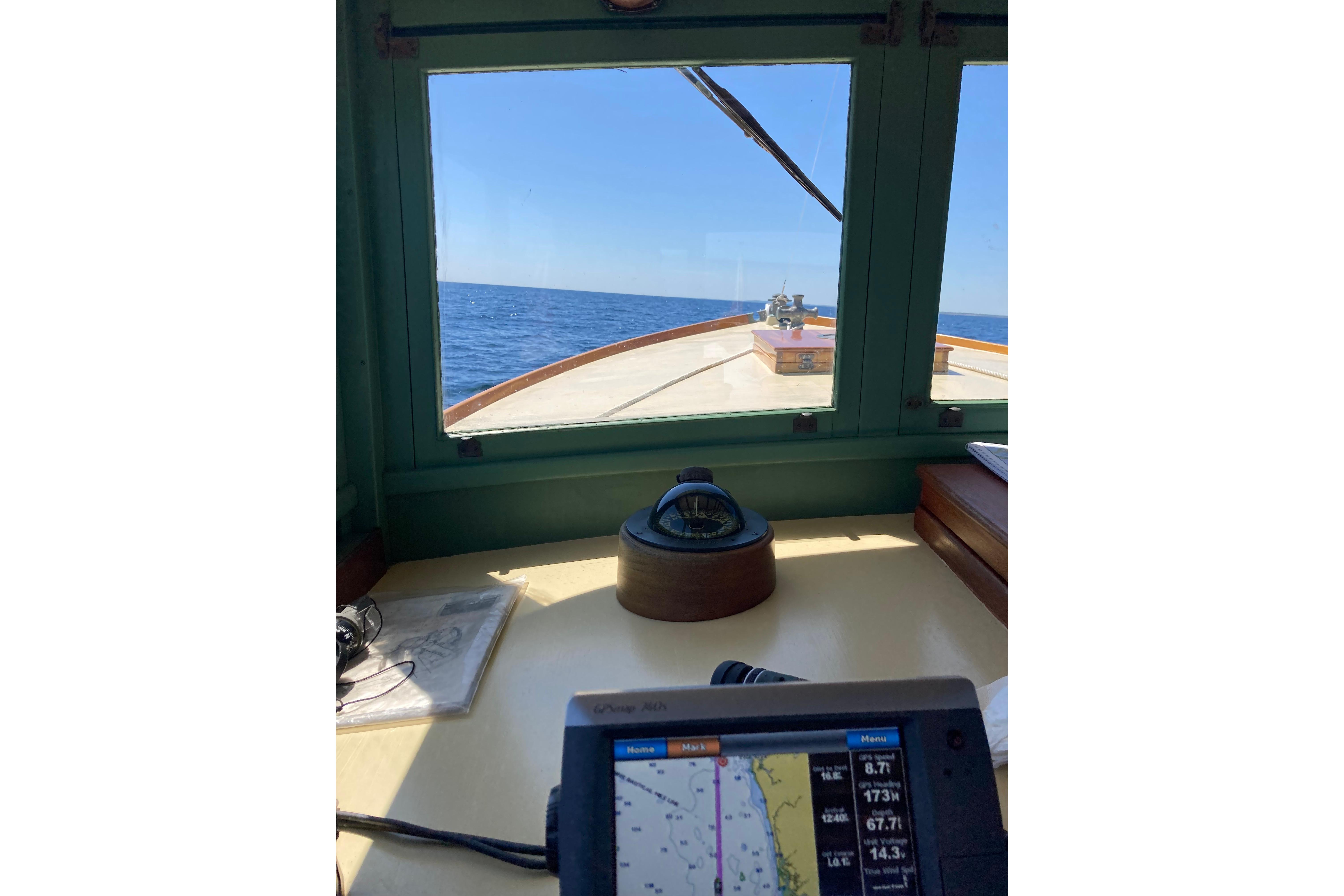 1929 Classic Lobster Cruiser cockpit view with navigation equipment and ocean horizon.