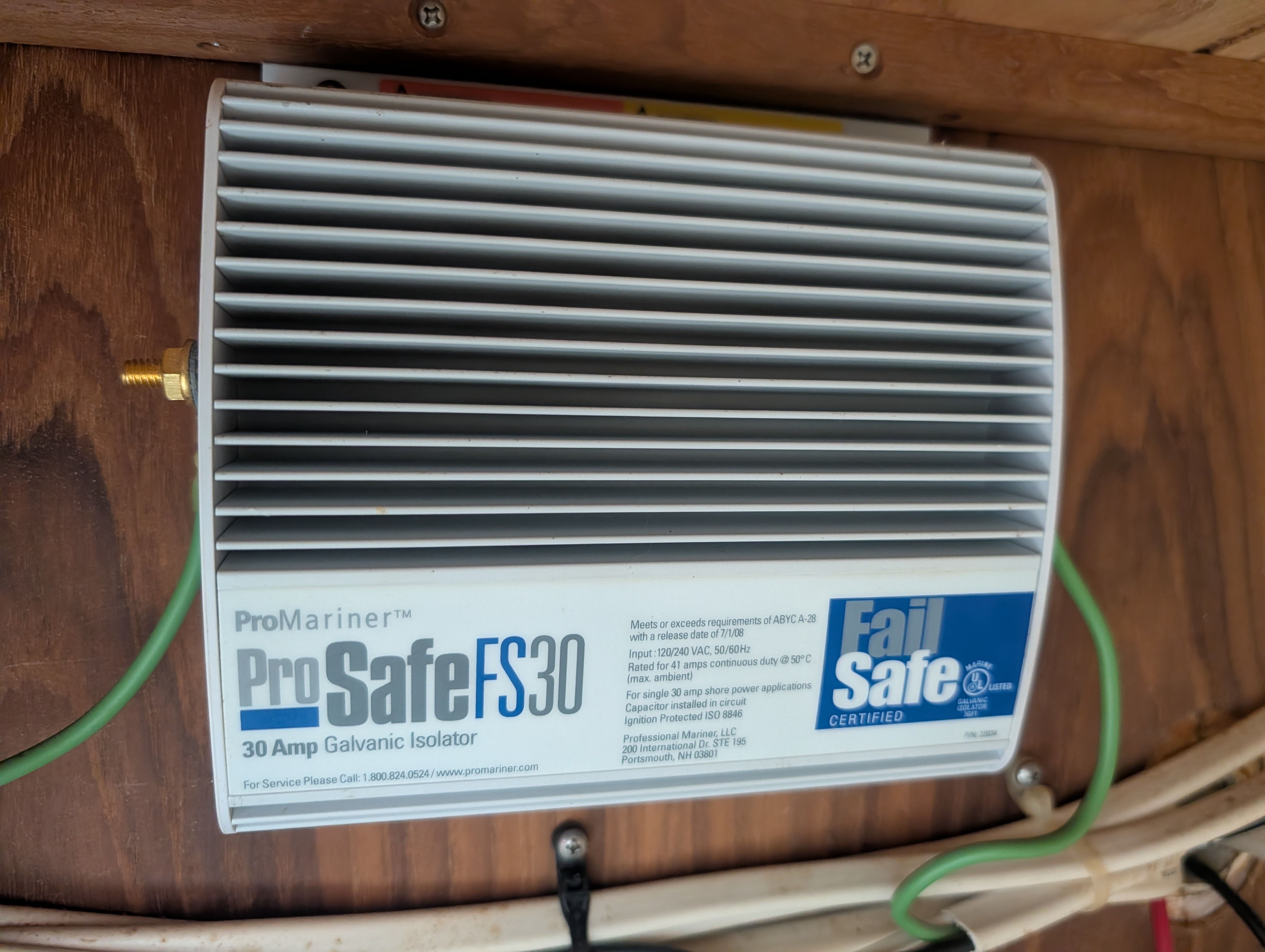 A ProMariner ProSafe FS30 galvanic isolator is mounted on a wooden wall.