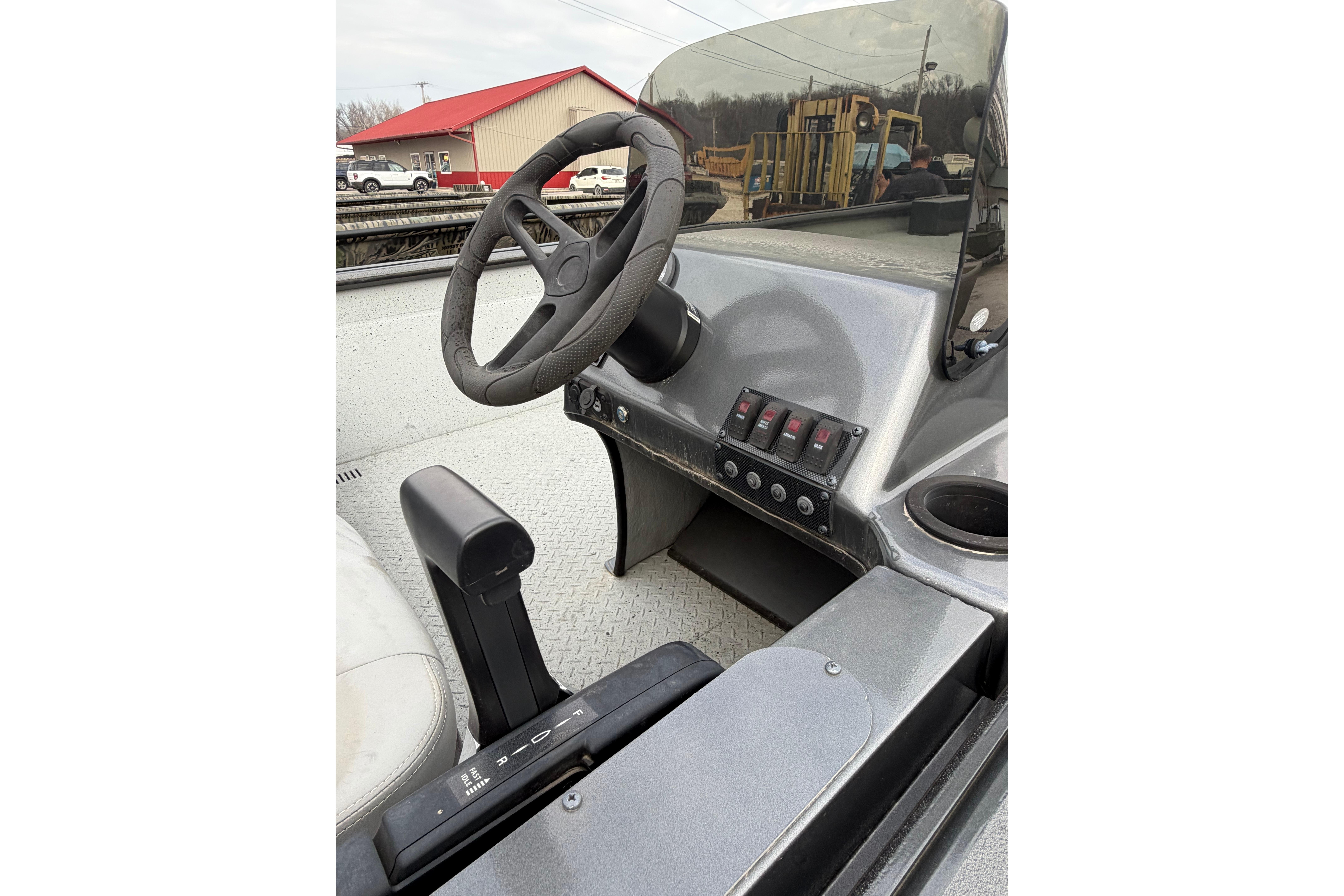 2023 SeaArk 180 RX boat dashboard with steering wheel and control panel.
