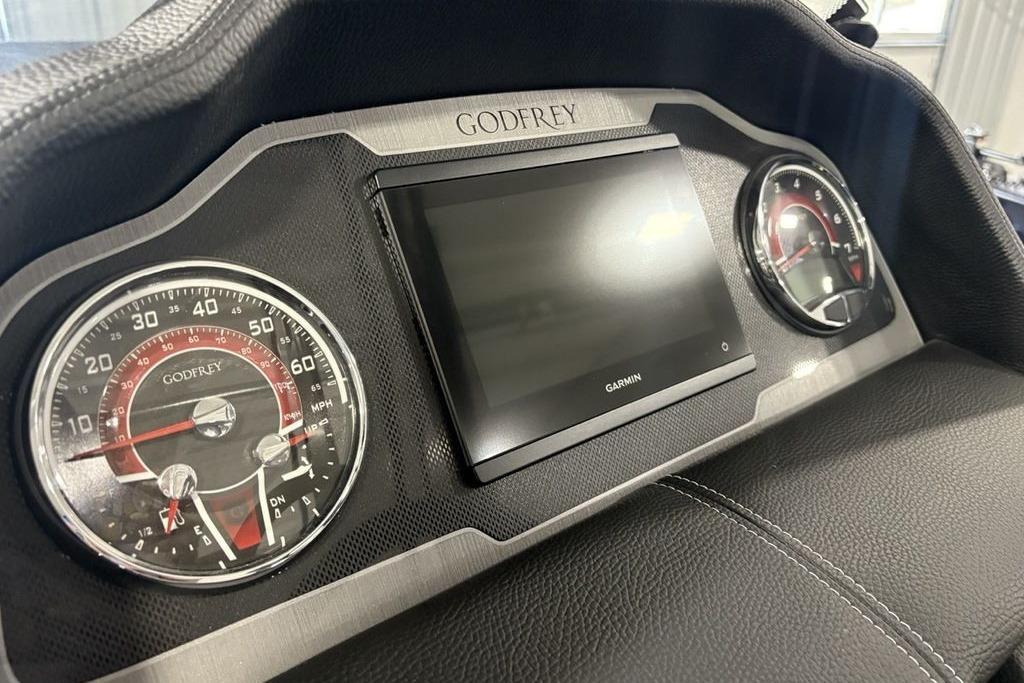 Dashboard of 2026 Godfrey Monaco 235 SFLC iMPACT 2.0 with Garmin display and gauges.