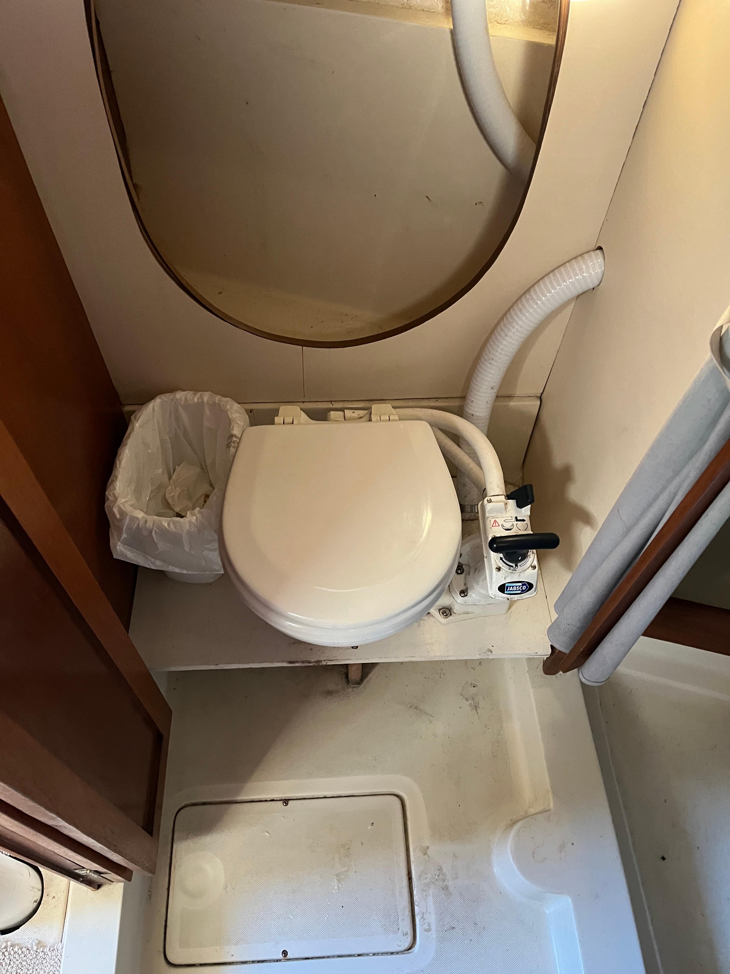 1979 O'Day 28 sailboat bathroom with toilet and waste bin.