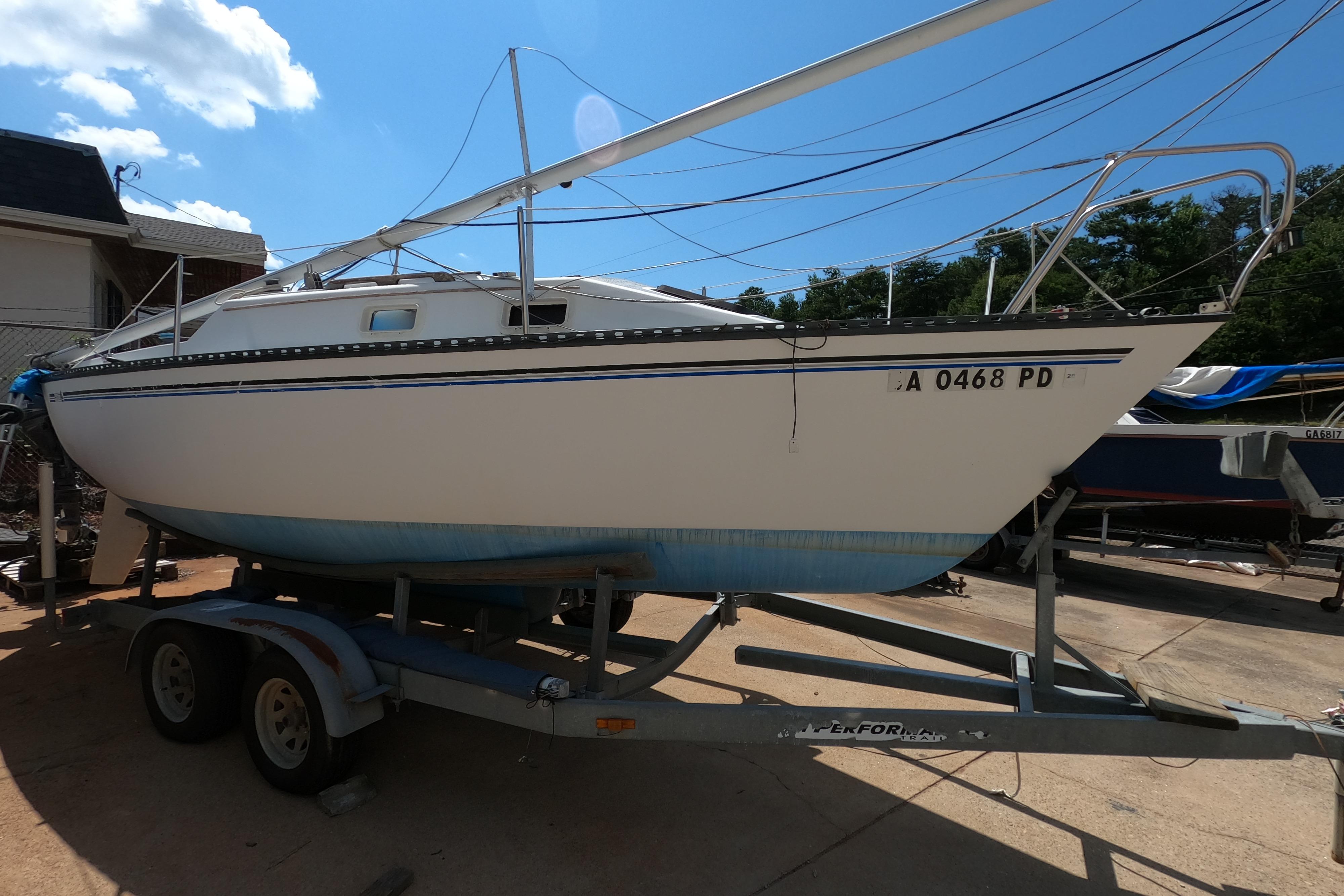 1984 Hunter 22 sailboat on trailer under clear blue sky.