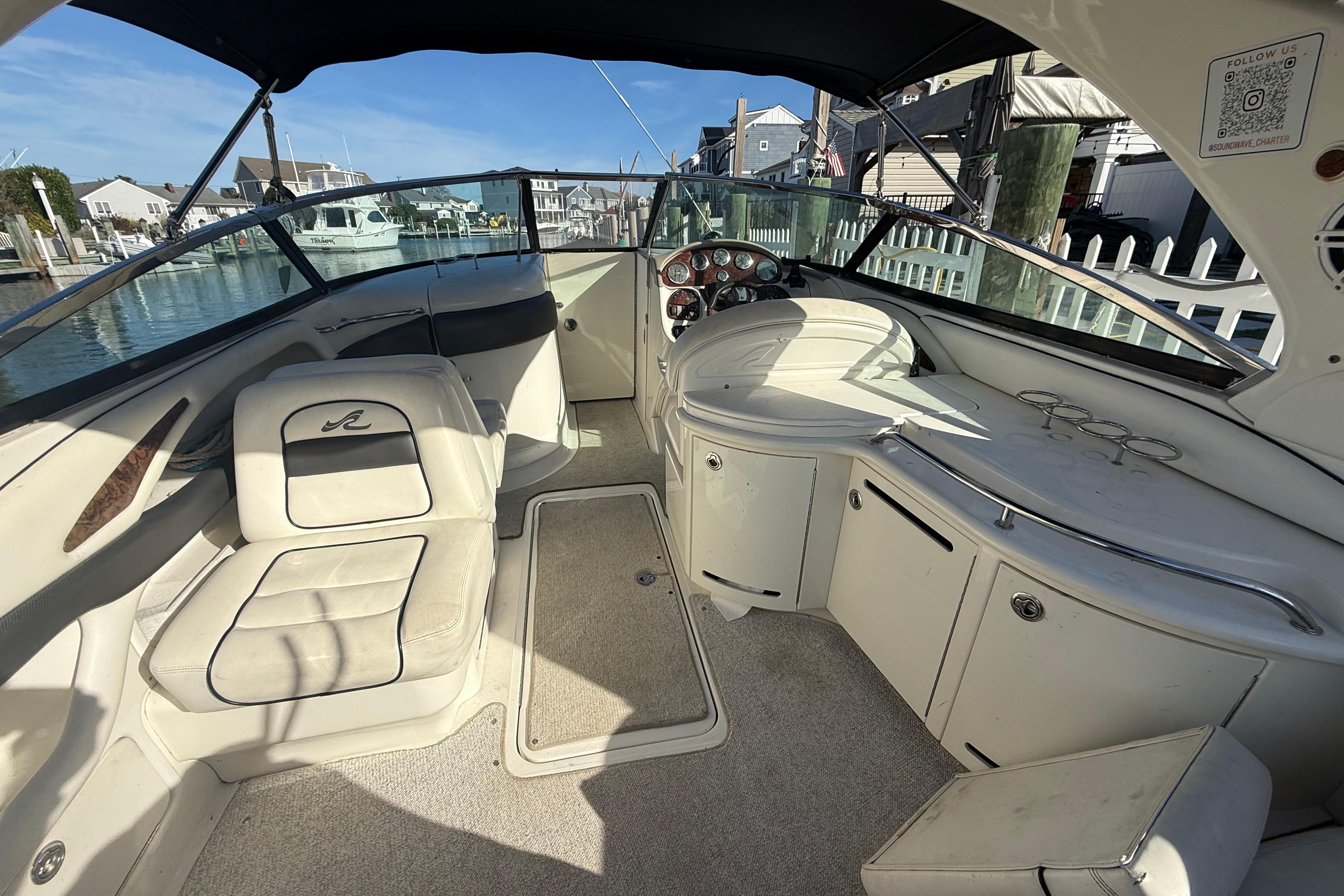 2005 Sea Ray 290 SLX boat interior with seating and dashboard, docked at marina.