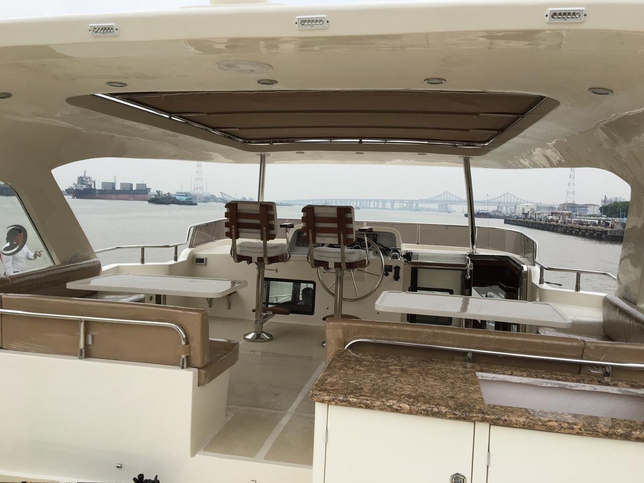Luxurious 2015 Selene 59 Ocean Clipper yacht interior with helm, seating, and ocean view.