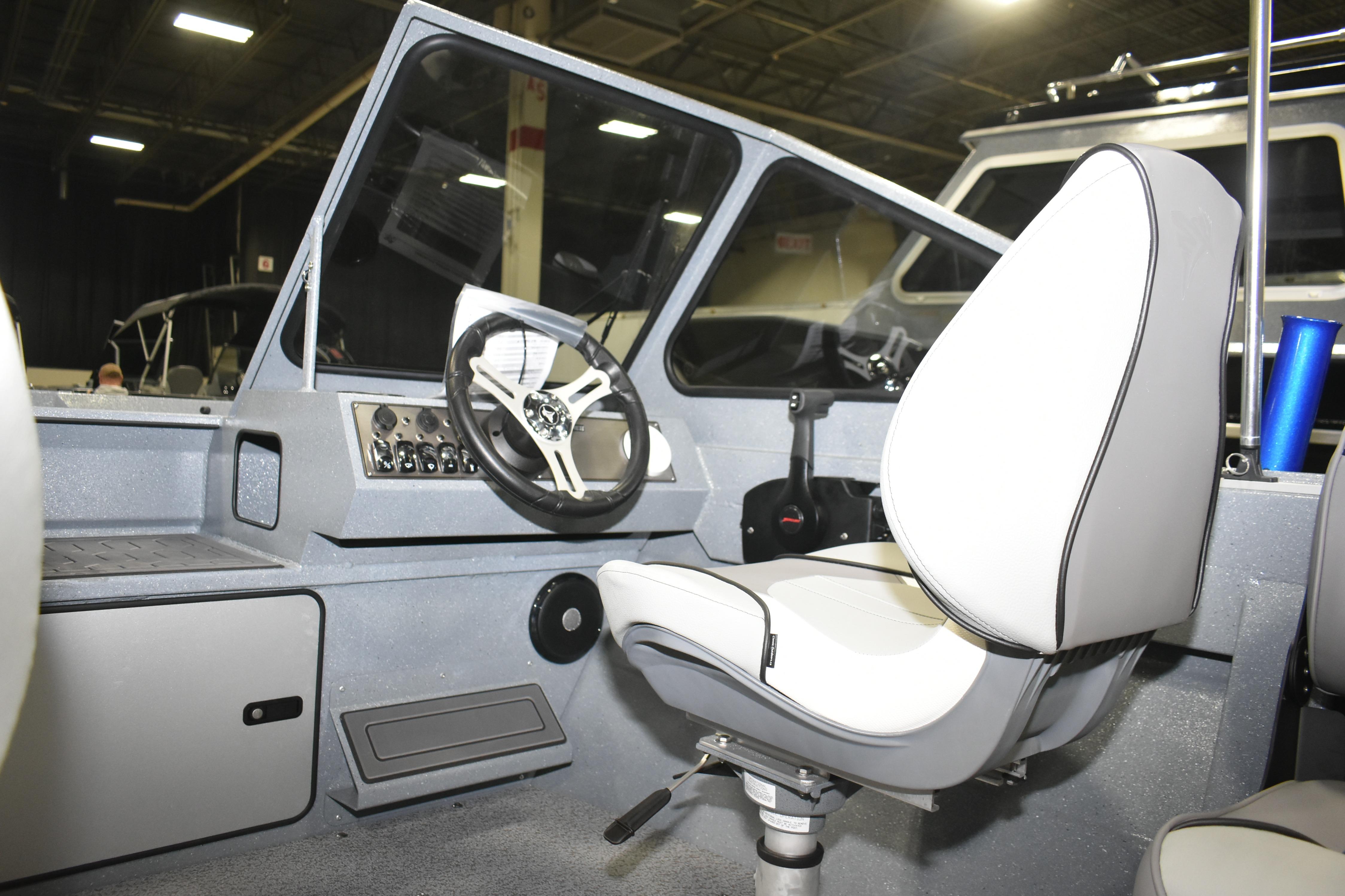 Interior of 2026 KingFisher 1825 Falcon boat with steering wheel and seat.