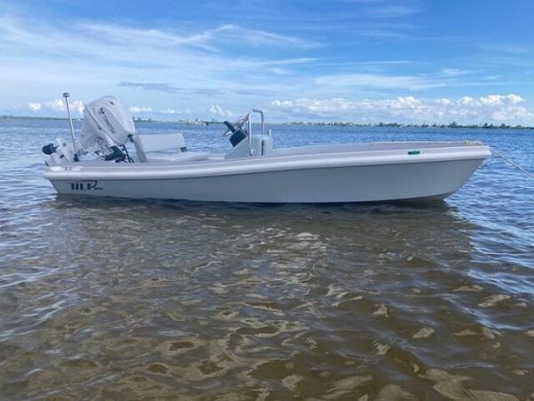 2024 Ultra Lite Tenders ULT 380 boat on calm water under blue sky.