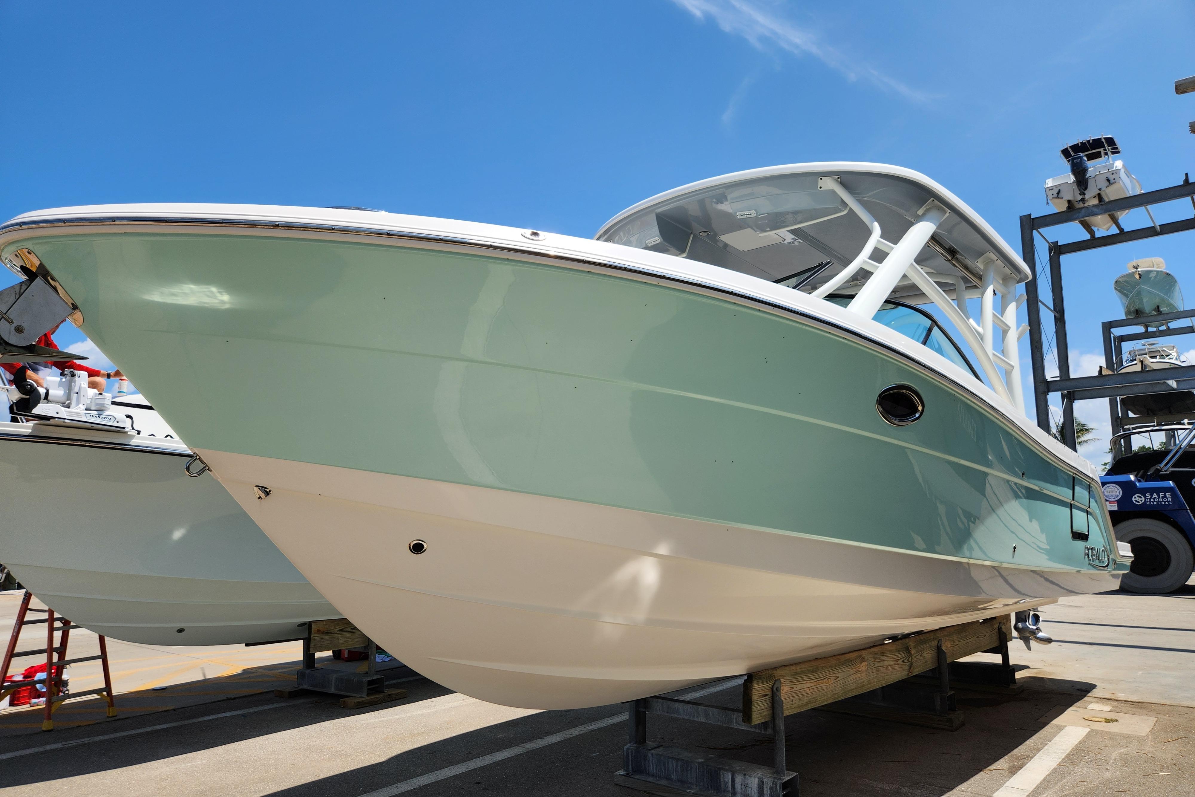 2019 Robalo R317 Dual Console boat on display under clear blue sky.