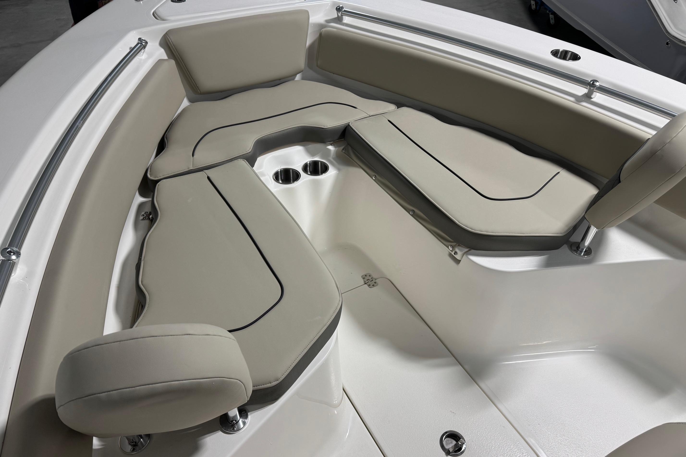 2026 Key West 239 FS boat interior with beige cushioned seating and cup holders.
