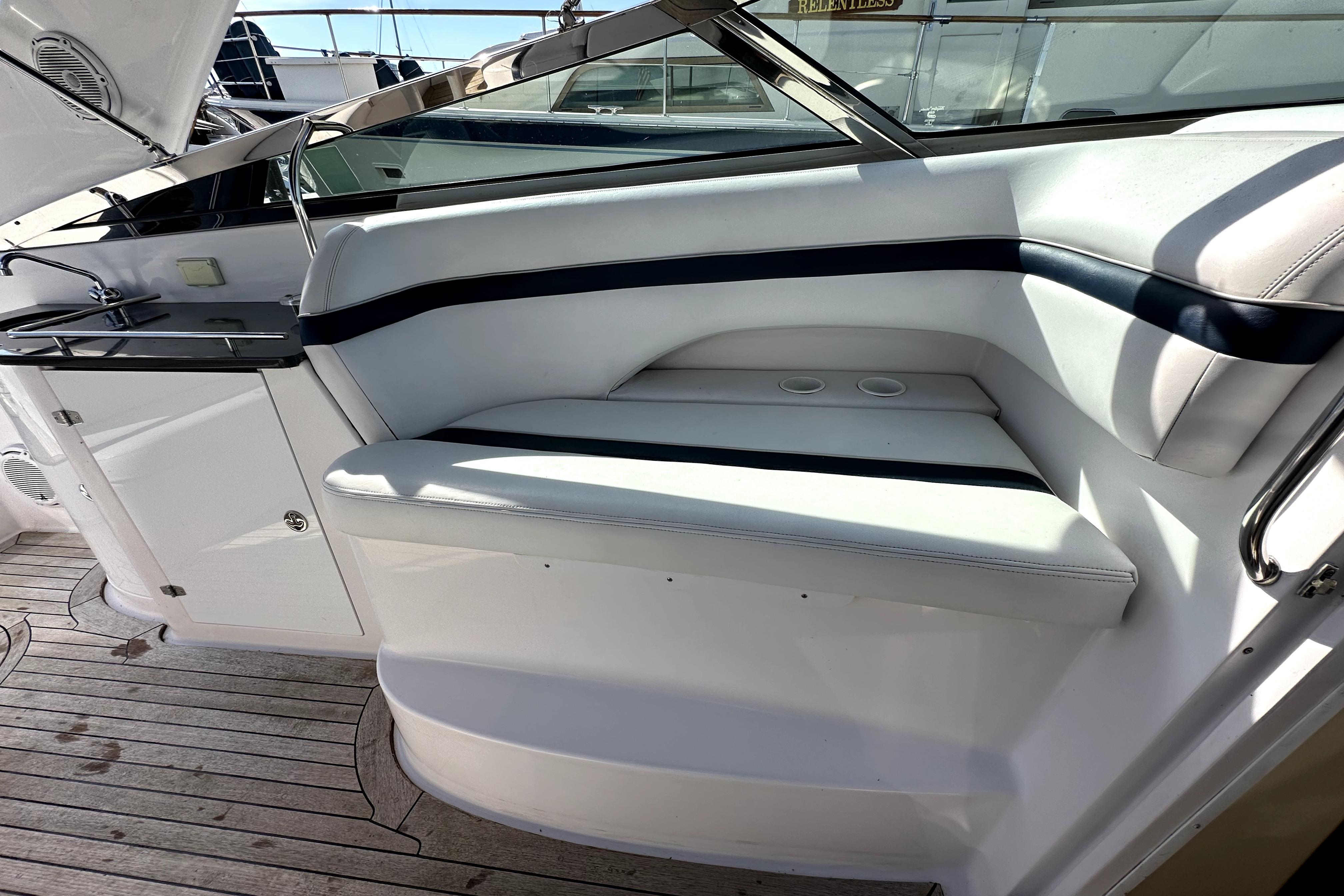2003 Donzi 39 ZSC boat interior with white seating and wooden deck.