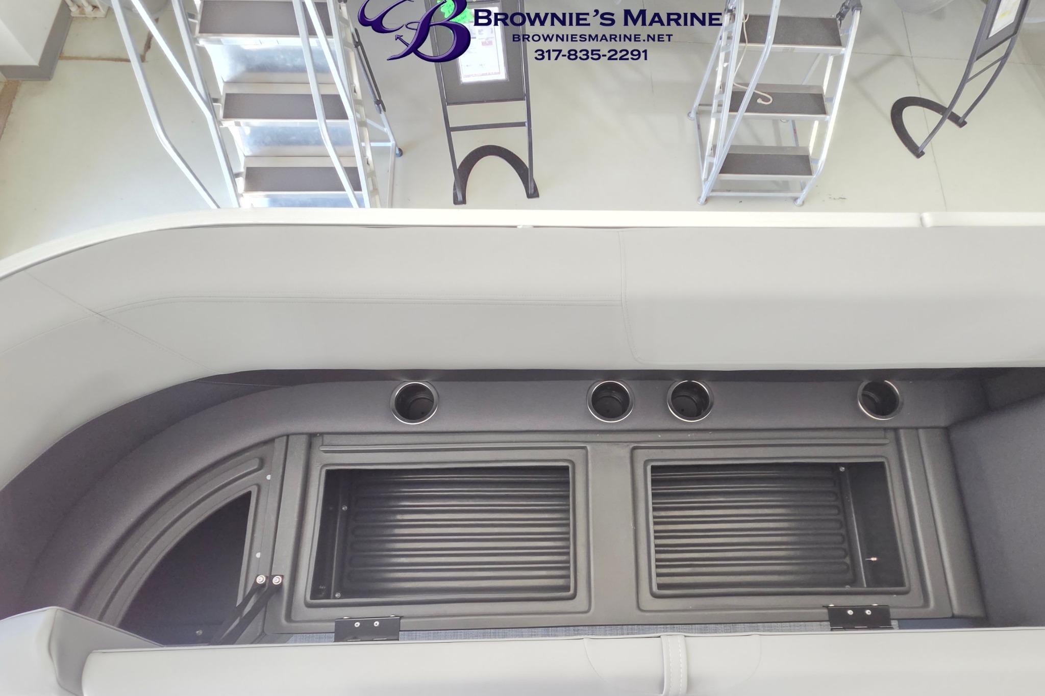 Interior view of 2026 Sun Tracker Party Barge 18 DLX with cup holders and storage compartments.