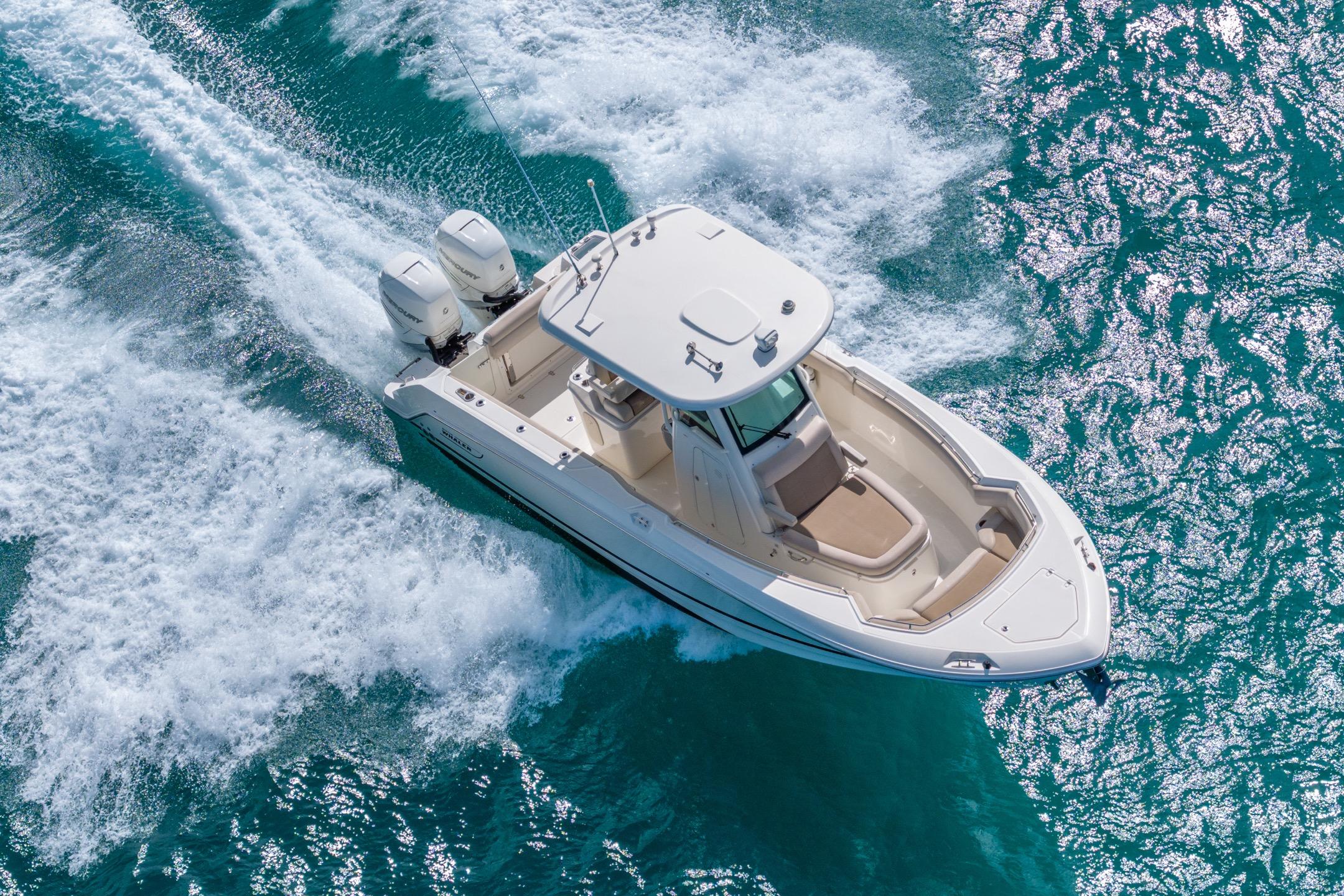 2016 Boston Whaler 280 Outrage cruising on clear blue water.