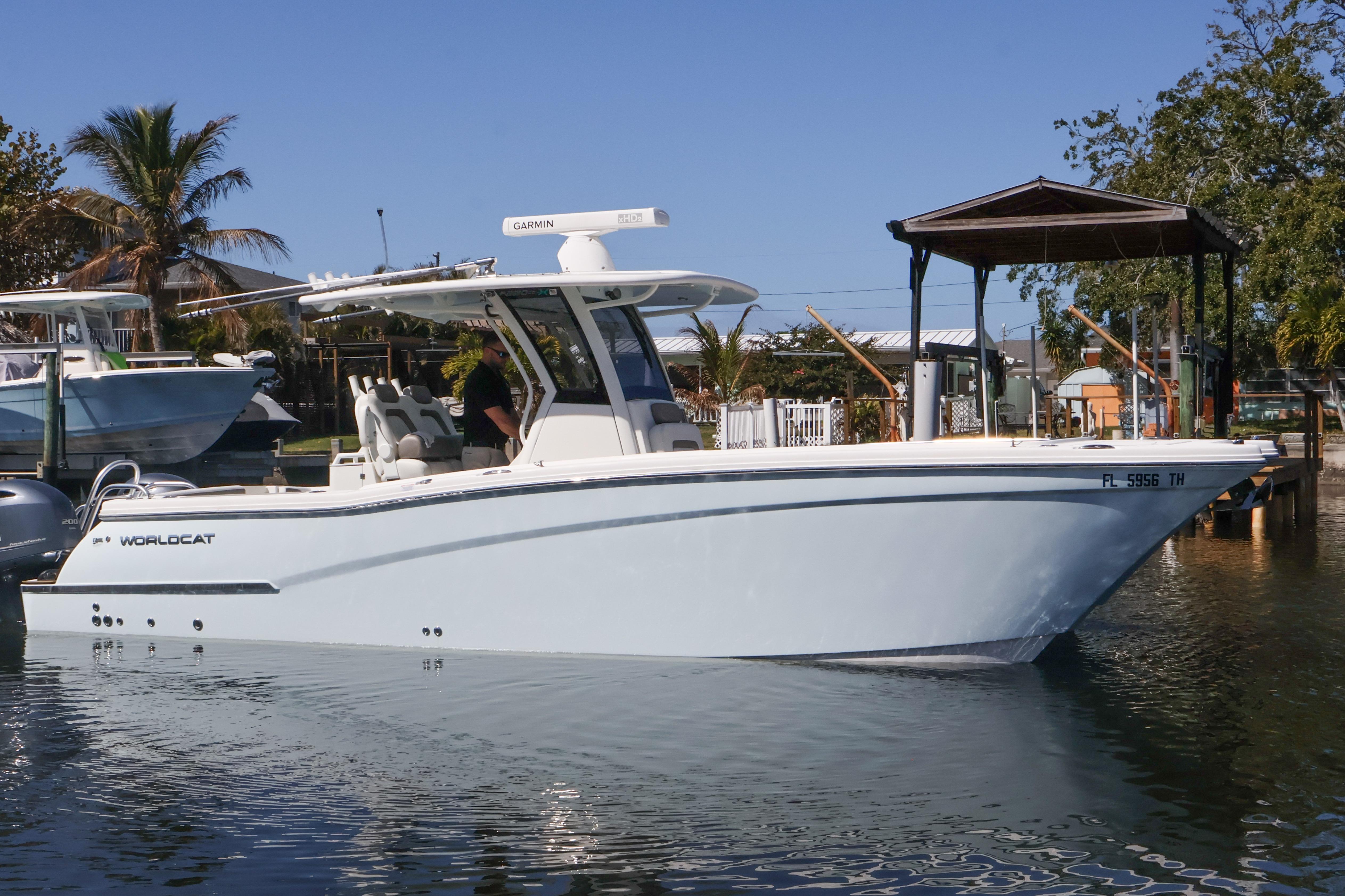 2022 World Cat 280 CC-X boat docked in a sunny marina setting.