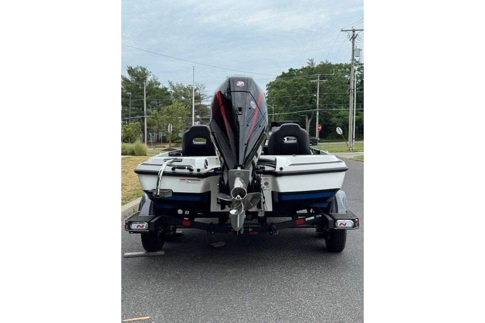 2026 Nitro Z21 XL boat on trailer, rear view, parked on road.
