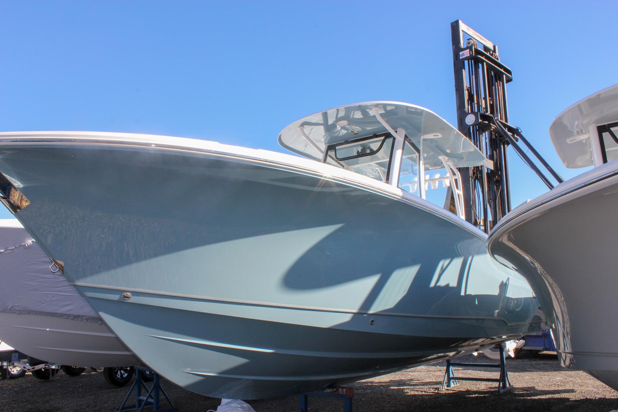 2026 Sea Hunt Ultra 285 SE boat displayed outdoors under clear blue sky.