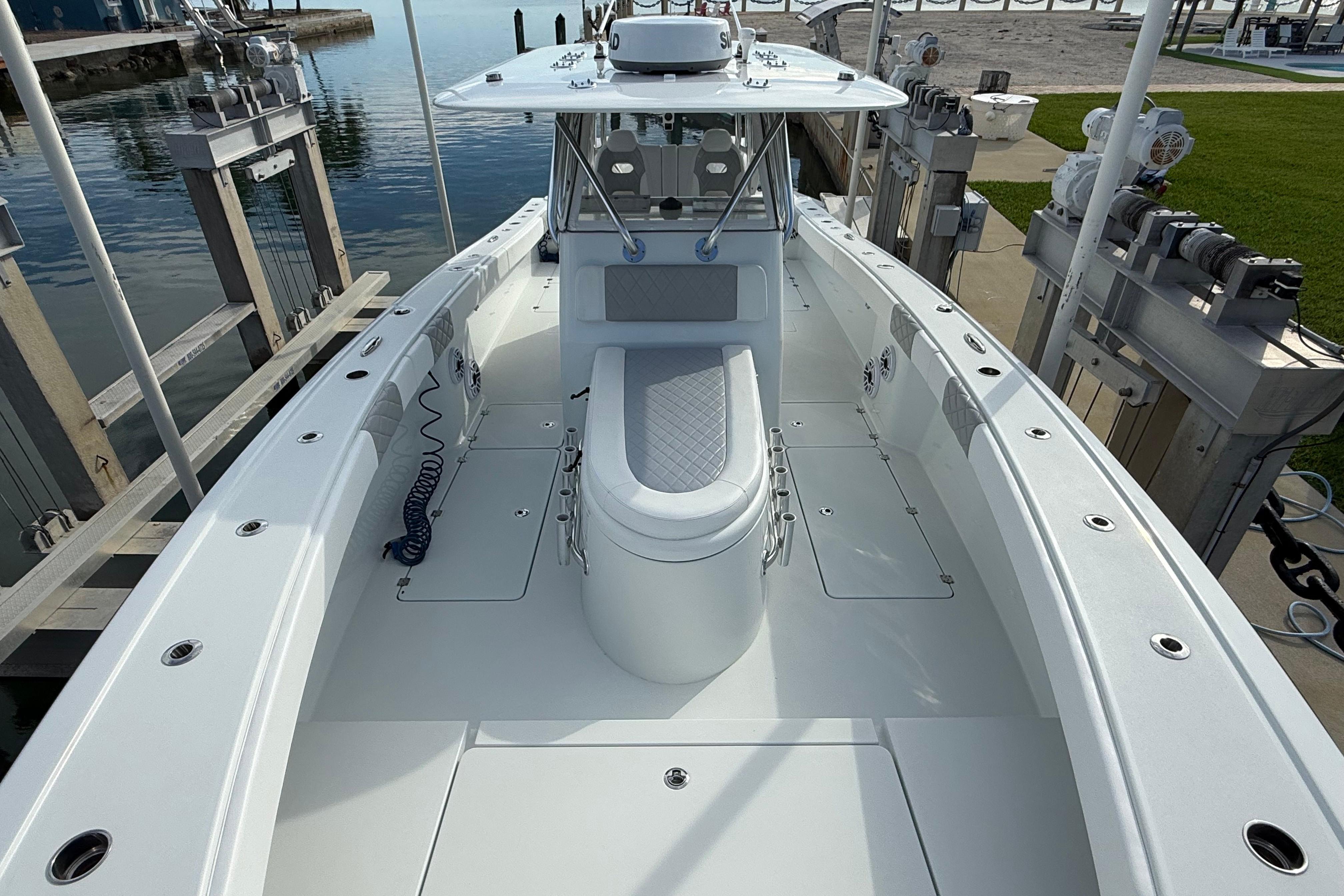 2022 Freeman 34VH boat docked, showcasing spacious deck and seating area.