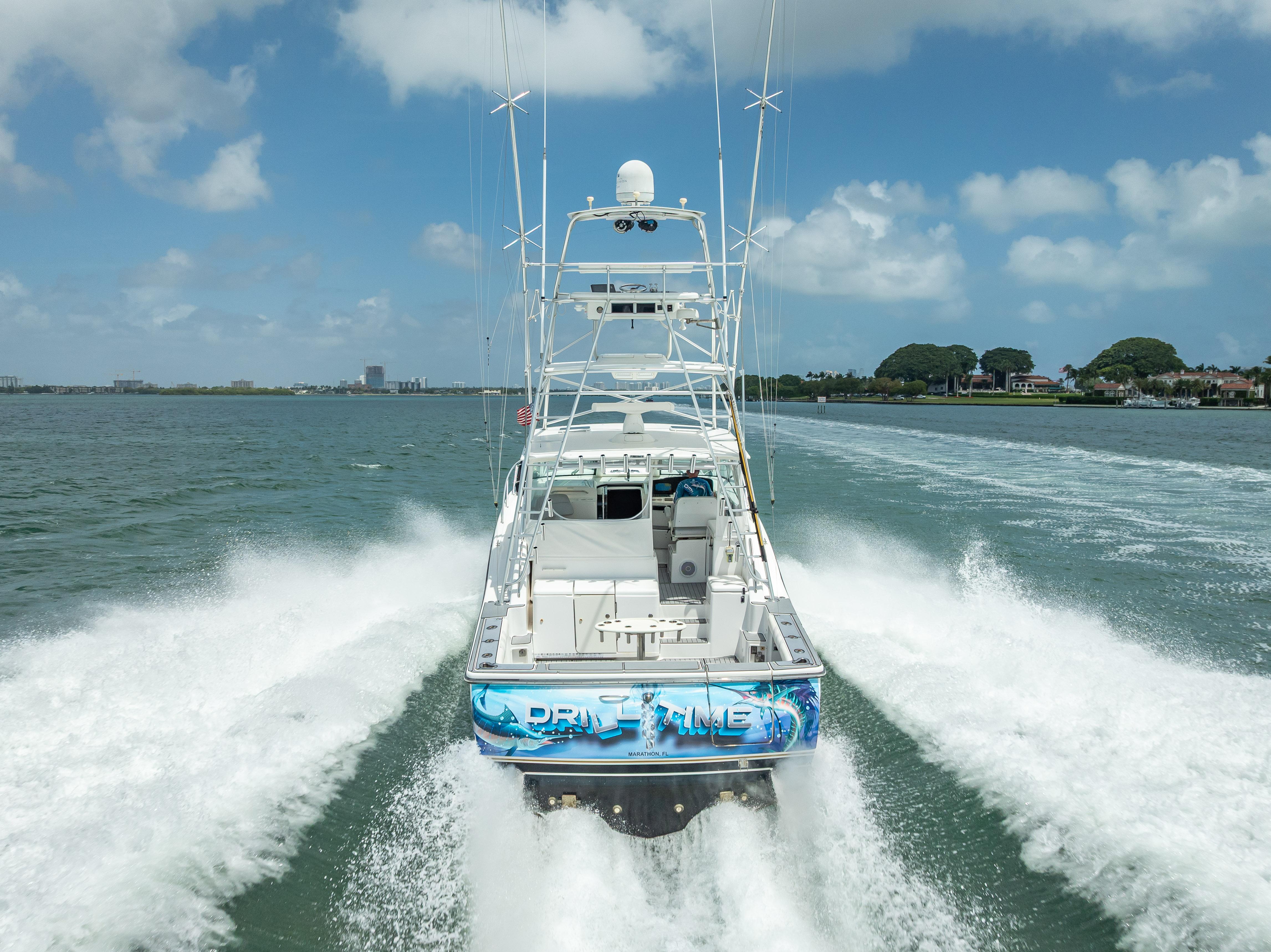 2006 Tiara Yachts 4200 Open cruising on water, rear view, clear sky.