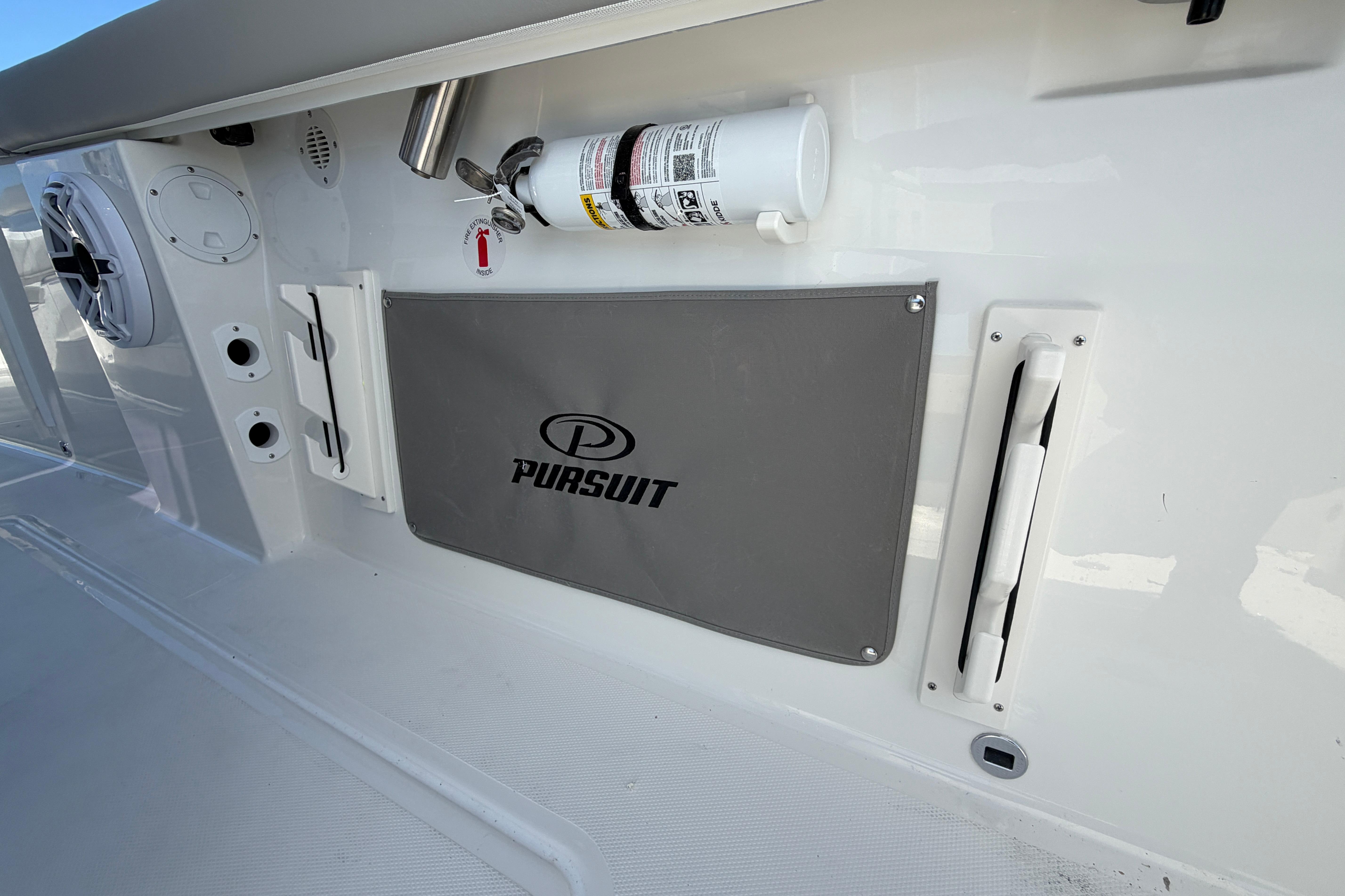 2026 Pursuit S 358 Sport boat interior with branded storage and safety equipment.