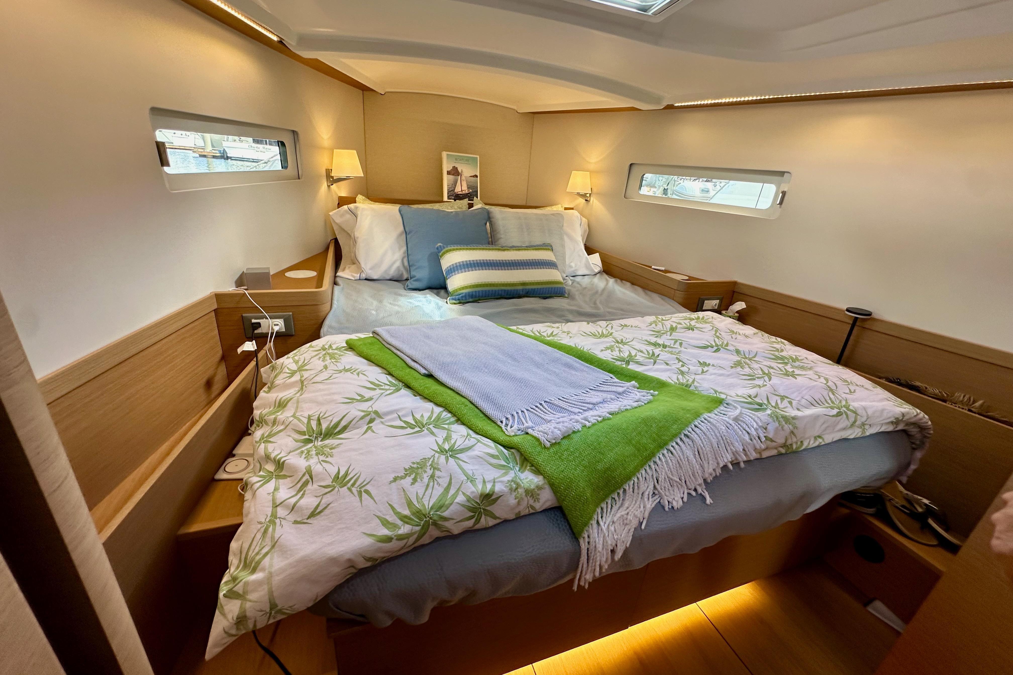 Luxurious cabin interior of 2024 Jeanneau Sun Odyssey 410 sailboat, featuring cozy bedding.
