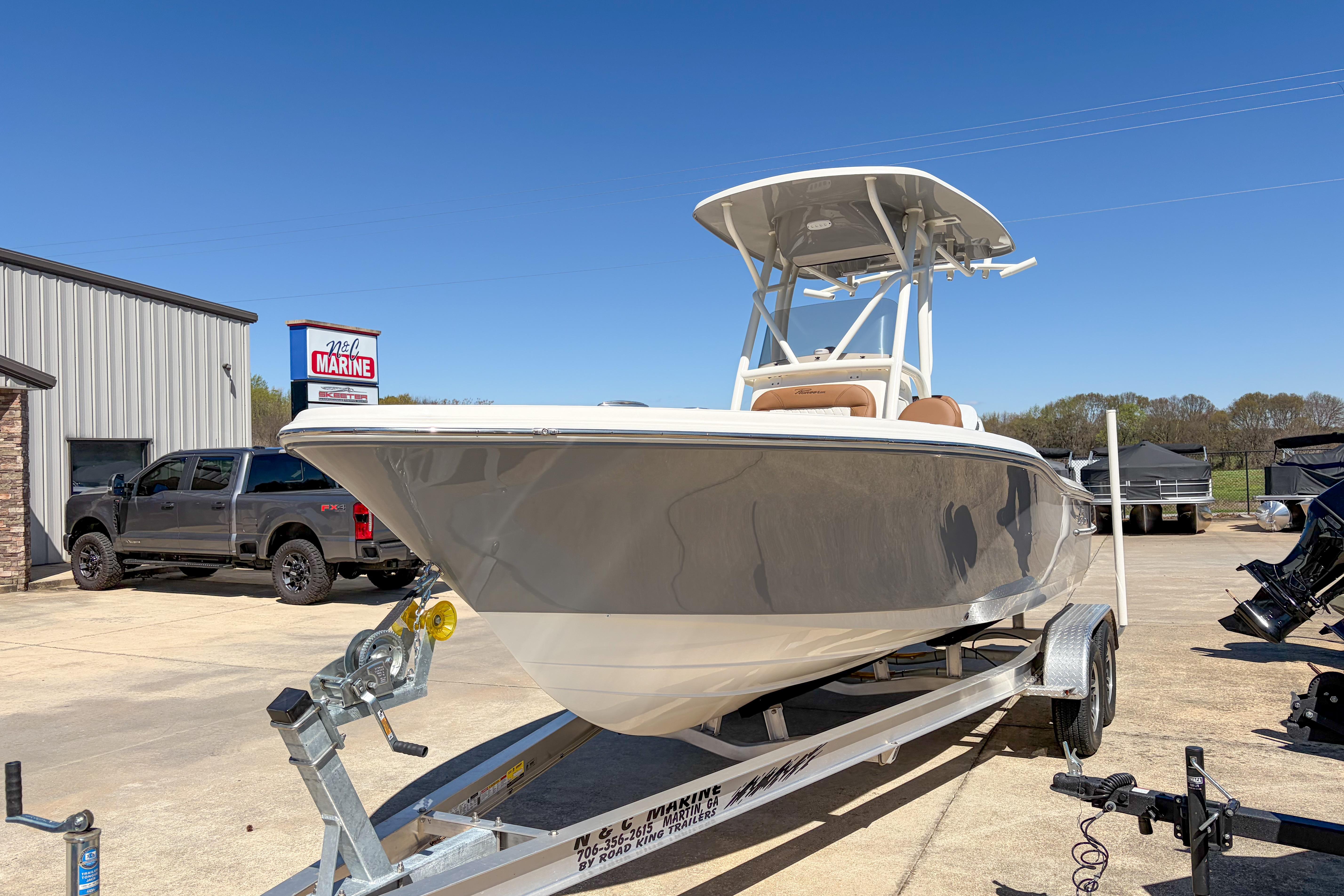 2026 Pioneer 220 Bay Sport boat on trailer at dealership, clear sky background.