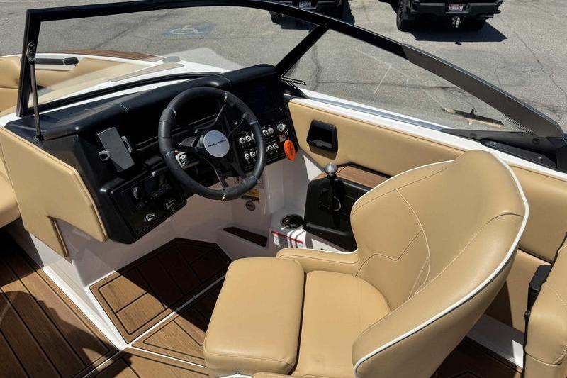 2023 Moomba Mojo Pro boat interior with tan seats and modern dashboard controls.