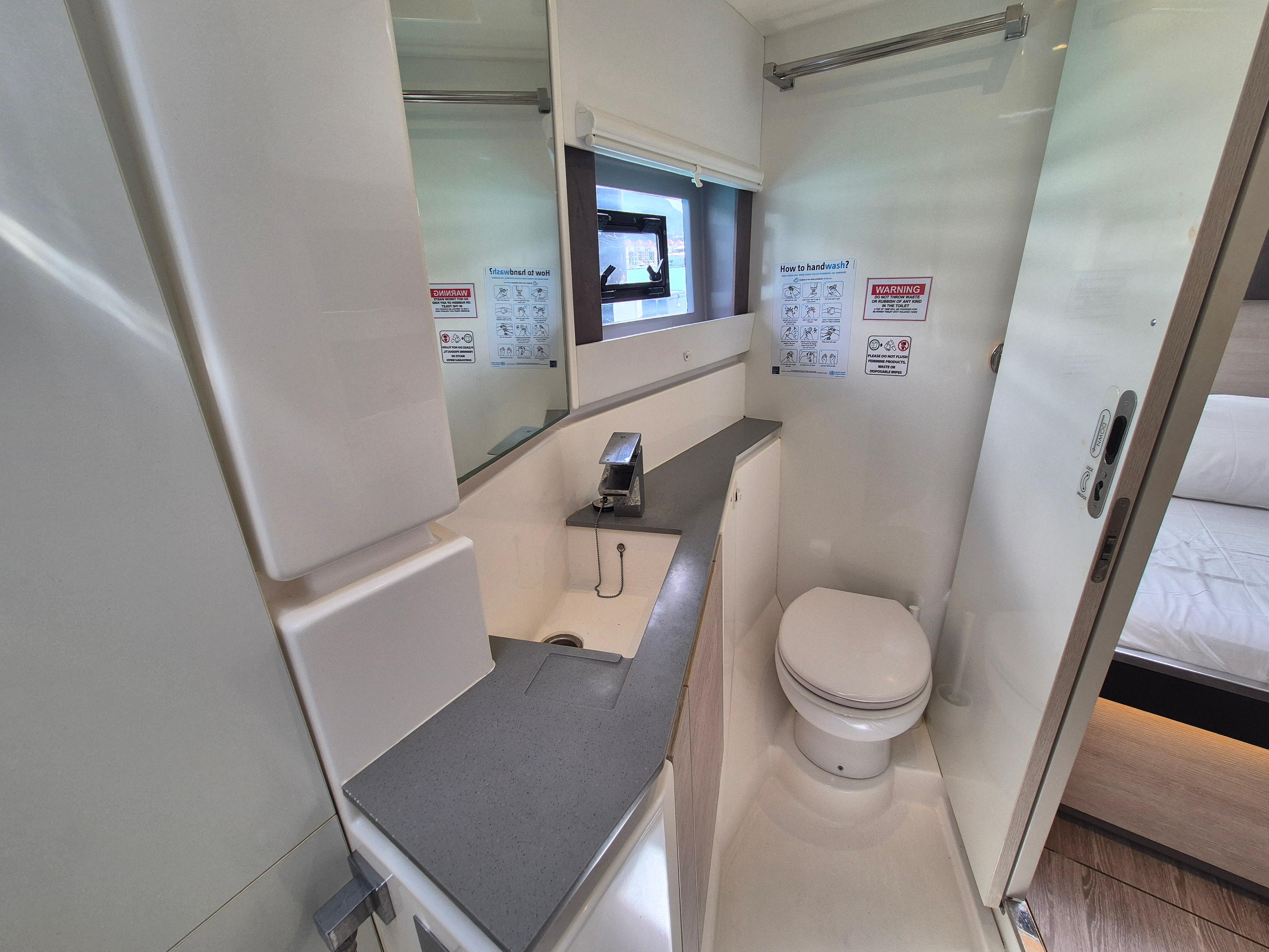 Modern bathroom in a 2020 Leopard 50 yacht, featuring sleek design and compact functionality.