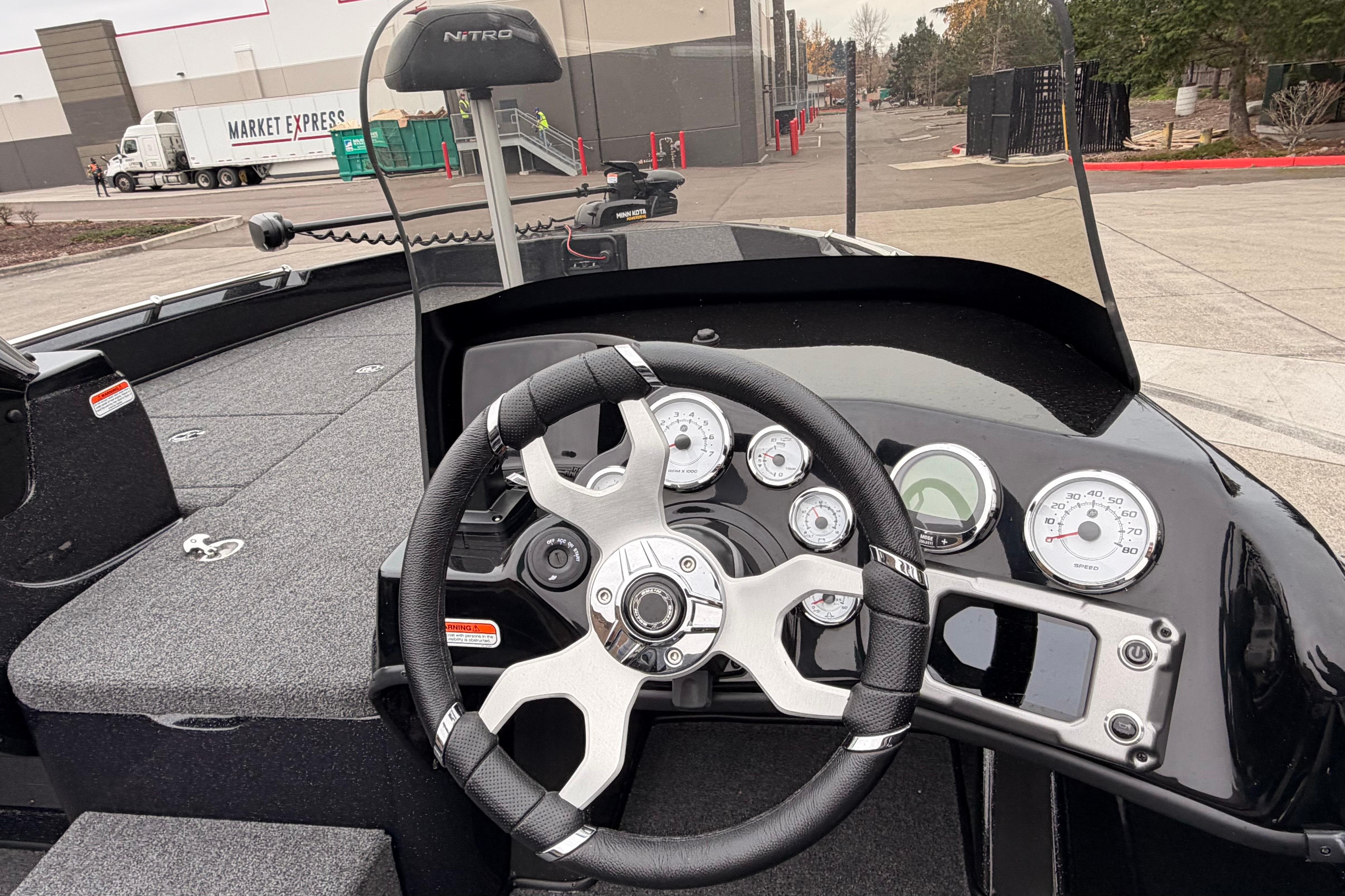 Steering console of a 2025 Nitro ZV19 boat, featuring modern gauges and controls.