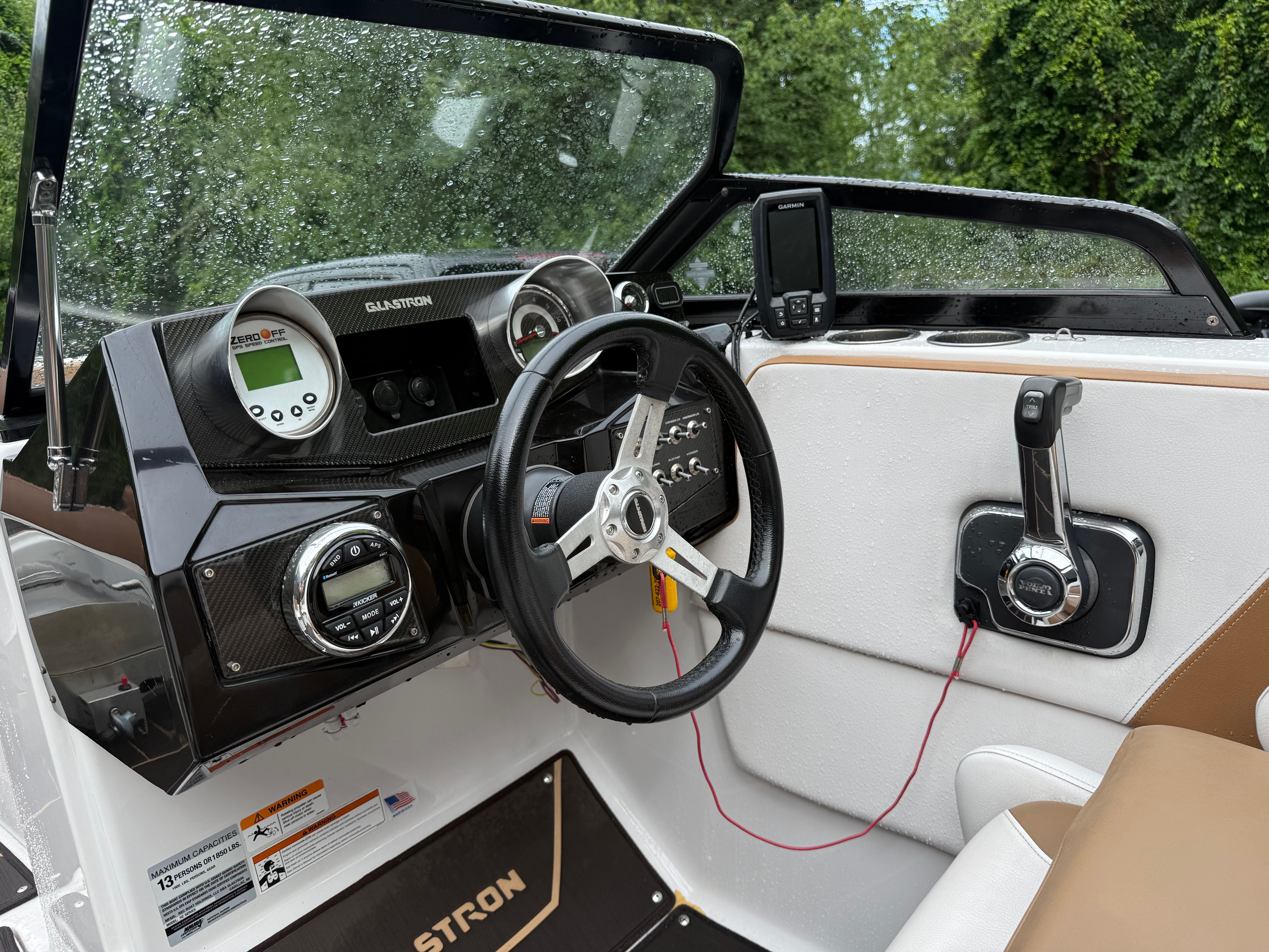 The image shows the cockpit of a 2019 Glastron GTDW 225 with steering wheel and instruments.