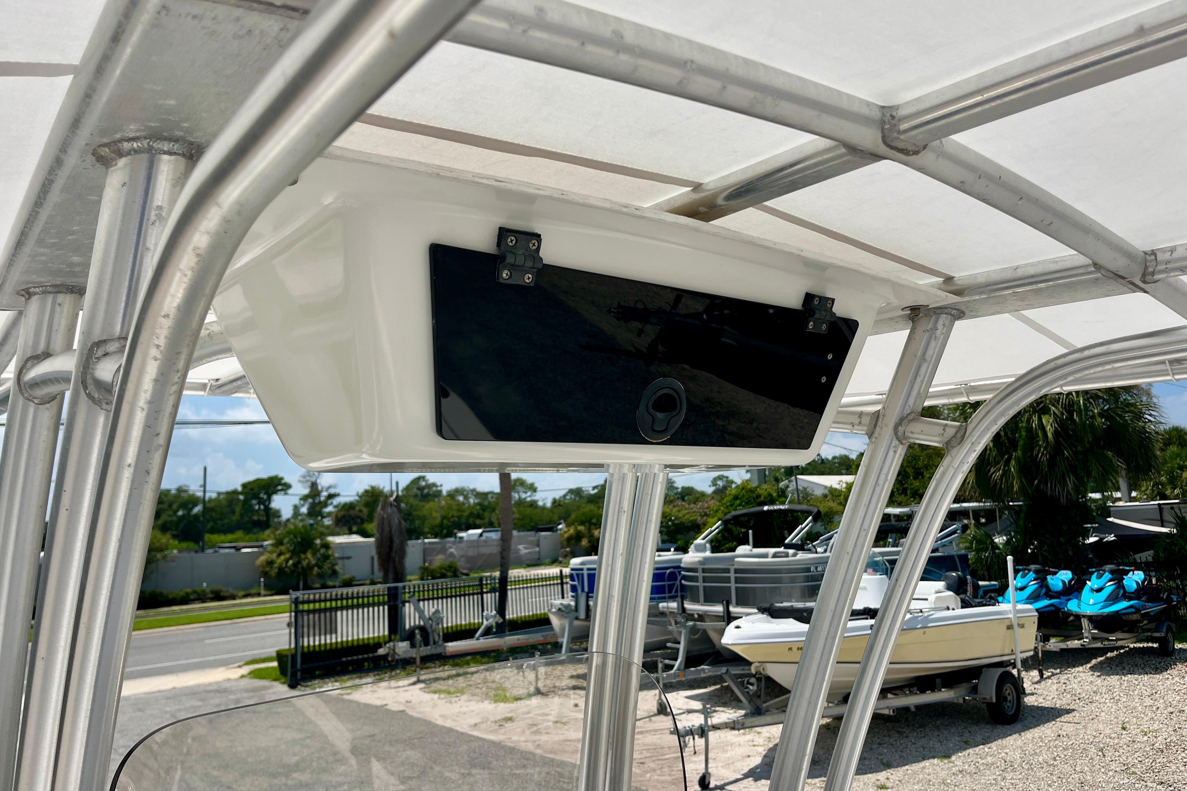 2016 Robalo R222 Center Console boat with T-top storage compartment.