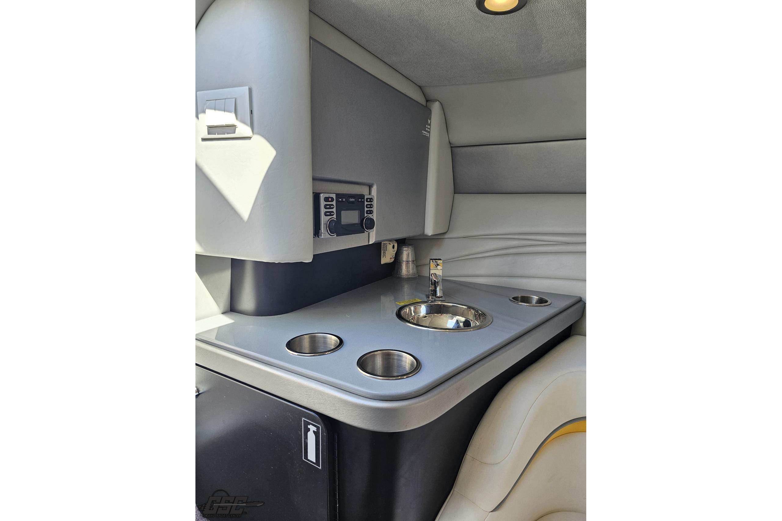 Interior of 2014 Formula 292 FASTech boat with sink and cup holders.
