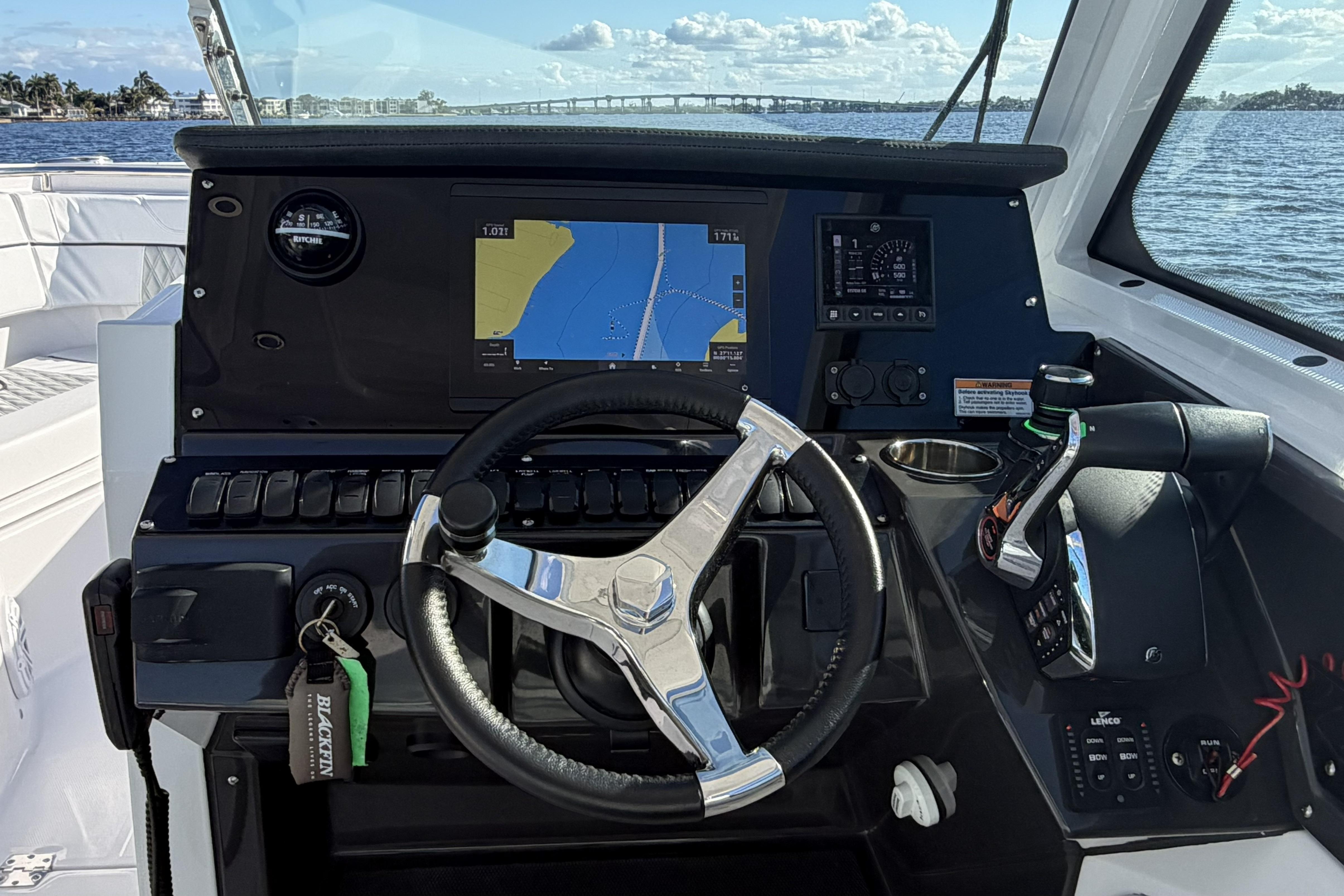 2025 Blackfin 272 DC boat dashboard with navigation system and steering wheel.