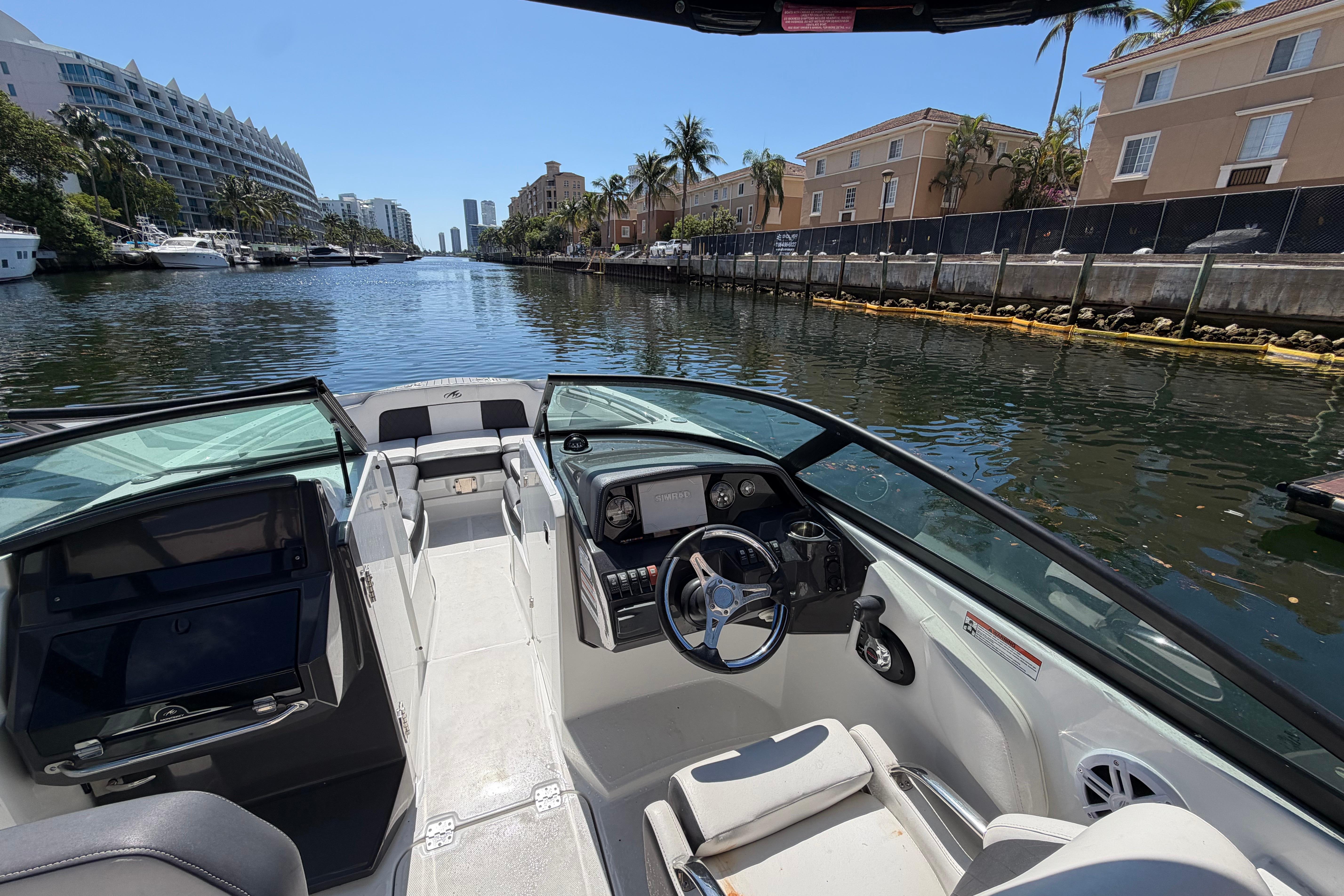 2022 Monterey M-65 boat interior on a scenic canal with luxury buildings.