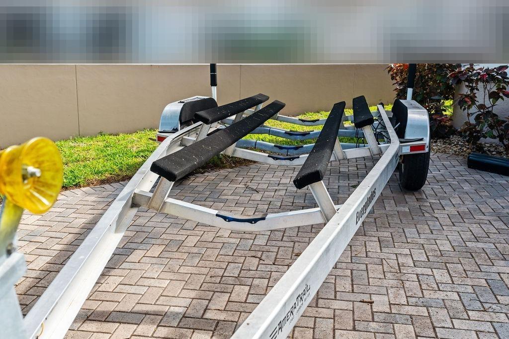 Boat trailer for Everglades 243 Center Console 2023 on paved surface.