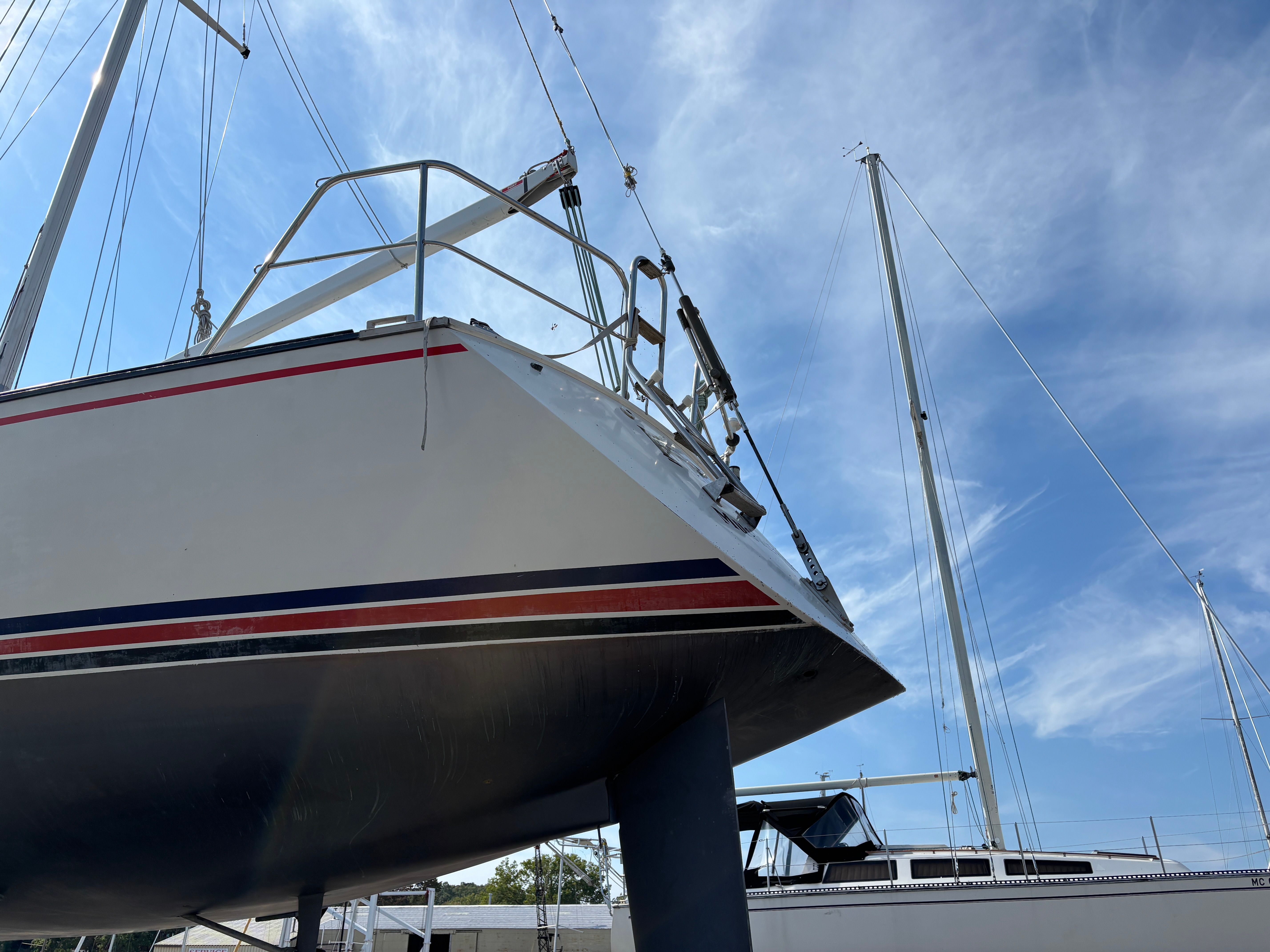 Sailboat Goman Express 35, 1987 model, docked under a clear blue sky.