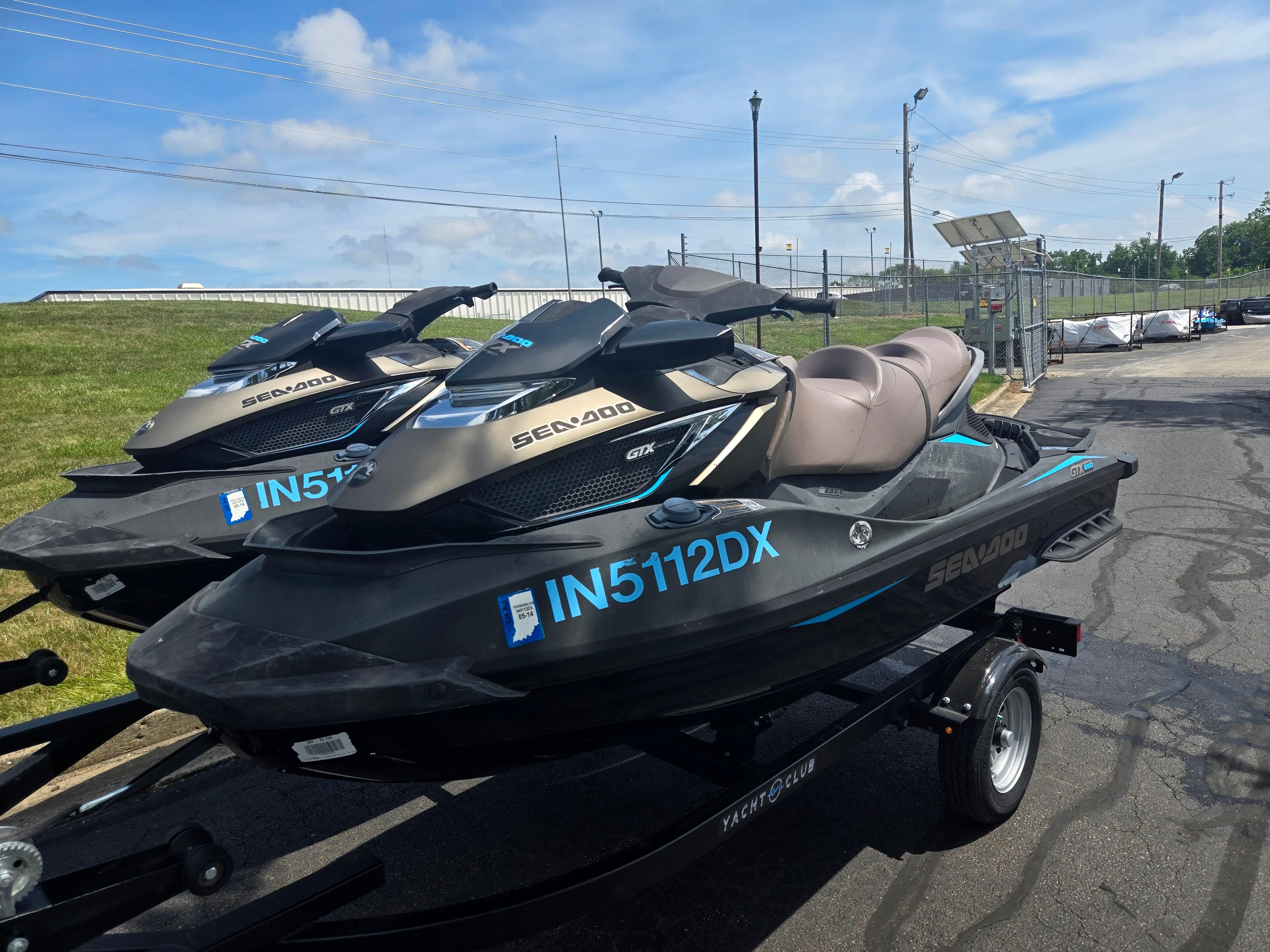 2016 Sea-Doo GTX Limited iS 260 jet skis on trailers, parked outdoors.