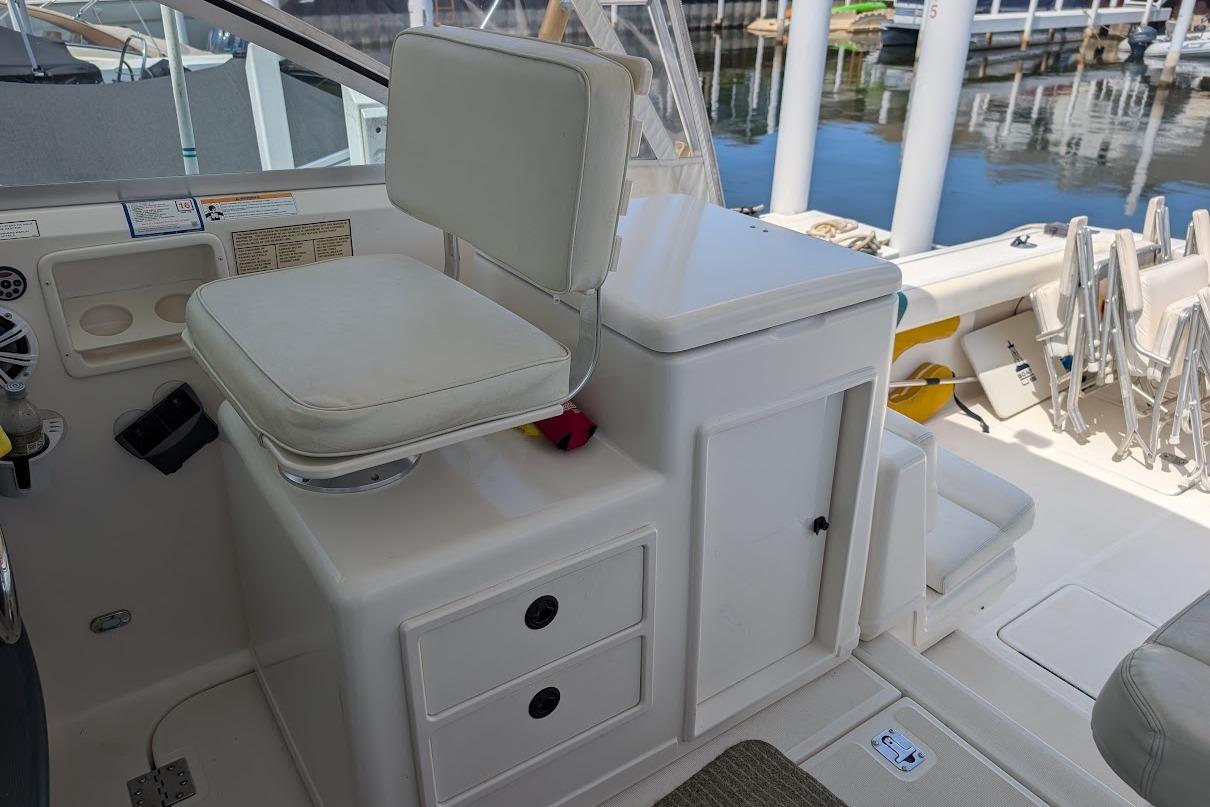 2000 Pursuit 3400 Express boat interior with white seating and storage compartments.