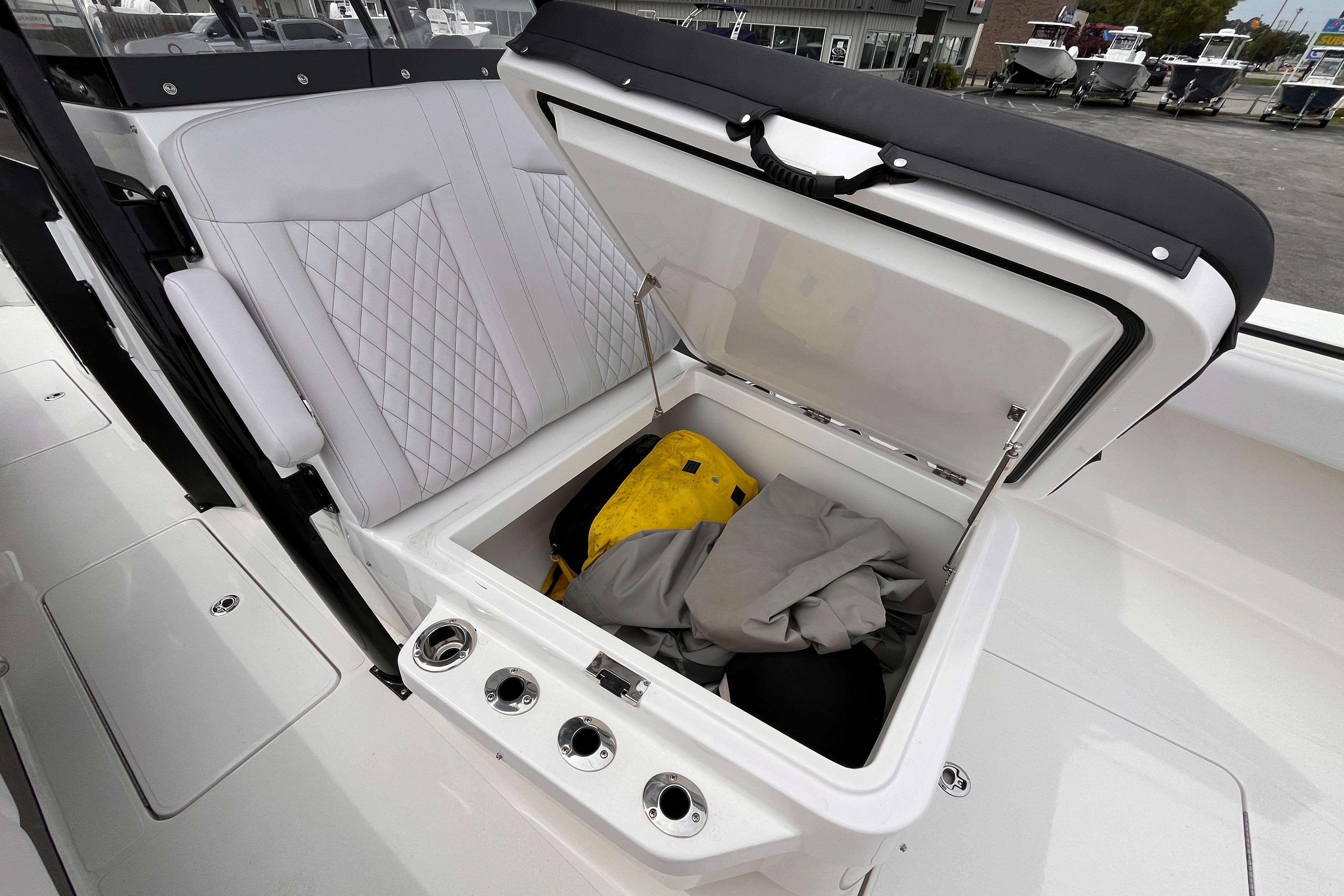 2024 Fountain 34 Tournament Edition boat with open storage compartment and white seating.