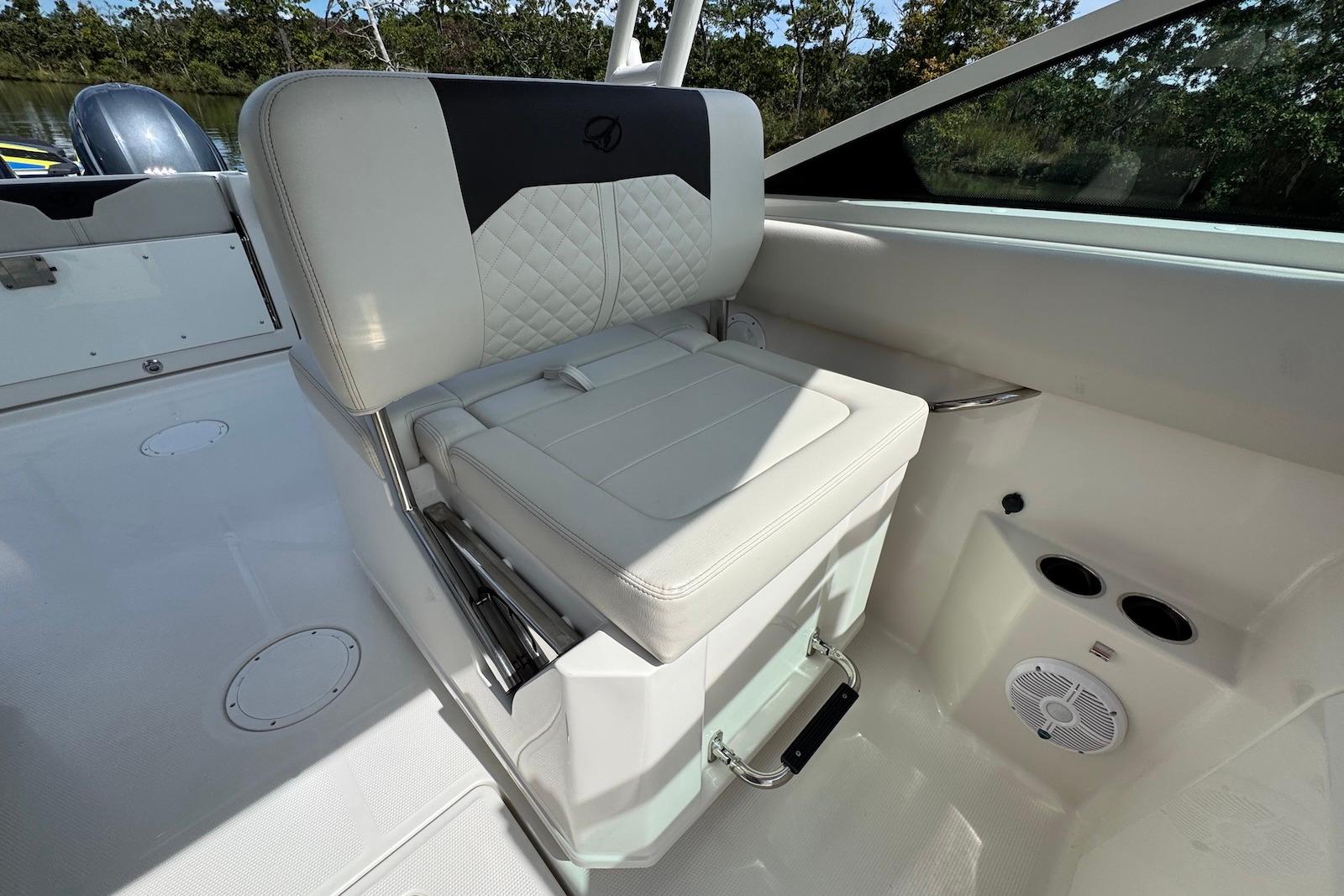 2022 Sailfish 276 DC boat interior with white cushioned seating and cup holders.