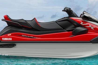 2026 Yamaha WaveRunner VX Cruiser in red, floating on clear blue water.