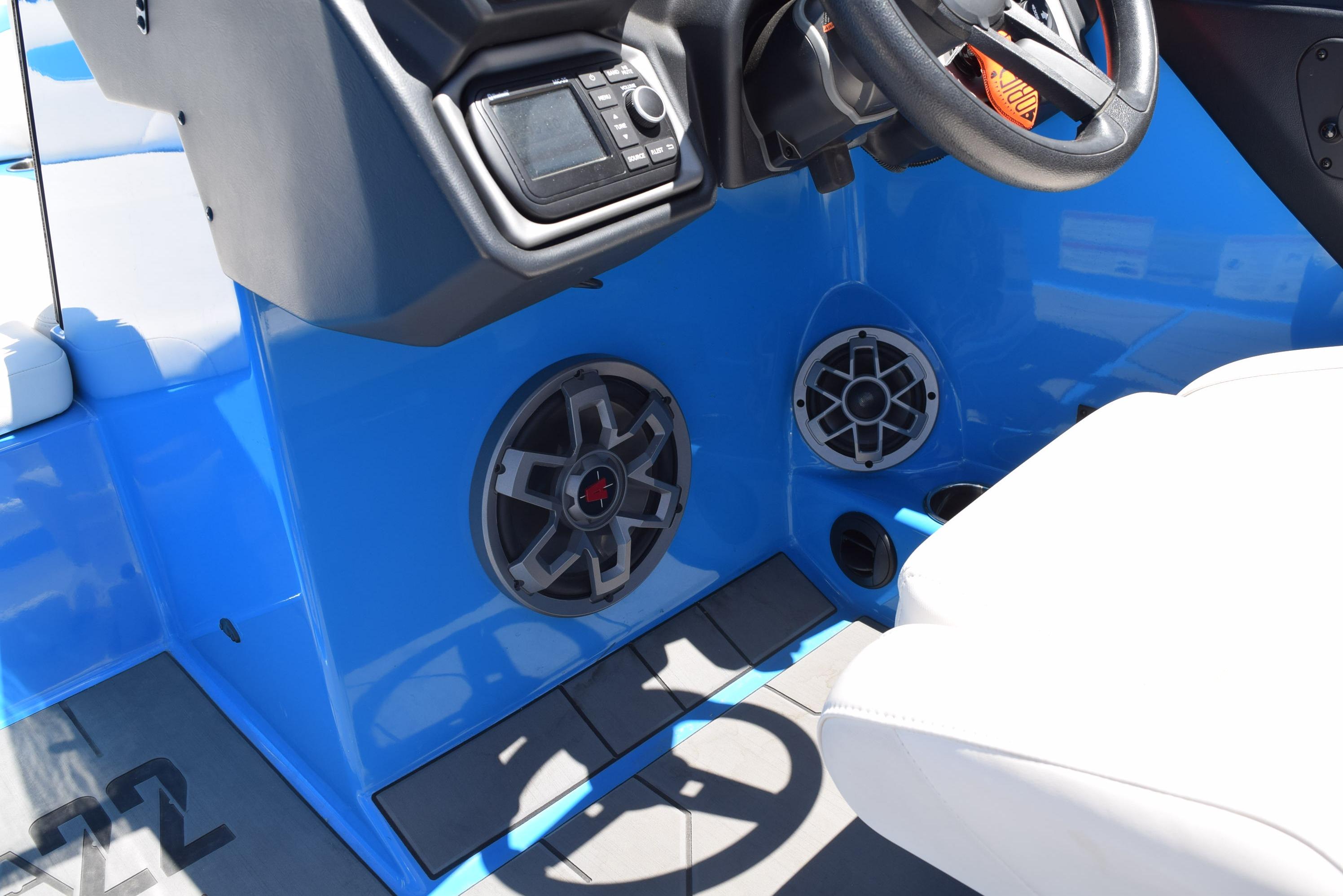 2019 Axis A22 boat interior with blue dashboard, steering wheel, and audio speakers.