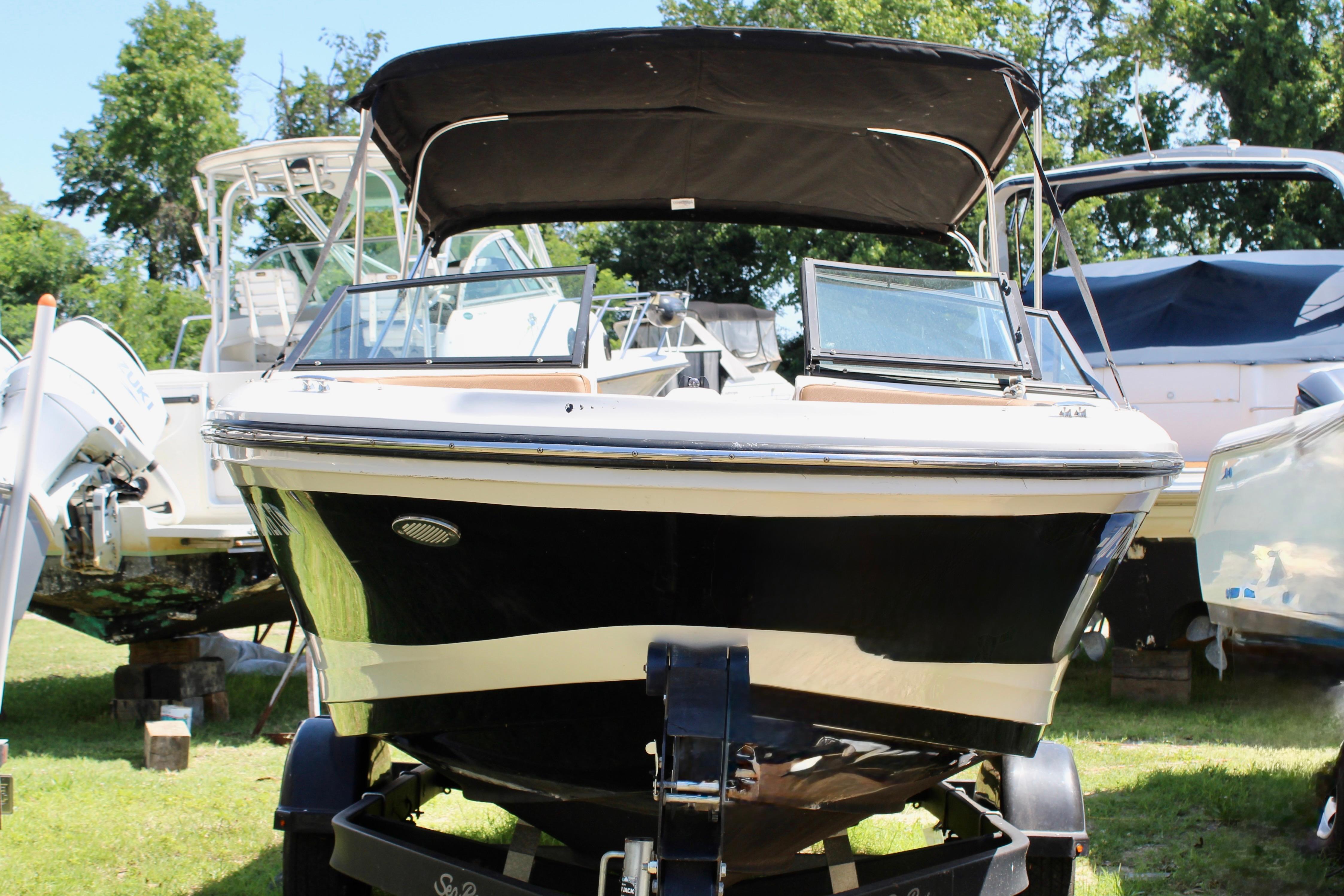 2018 Sea Ray SPX 190 Outboard boat on trailer, surrounded by other boats.